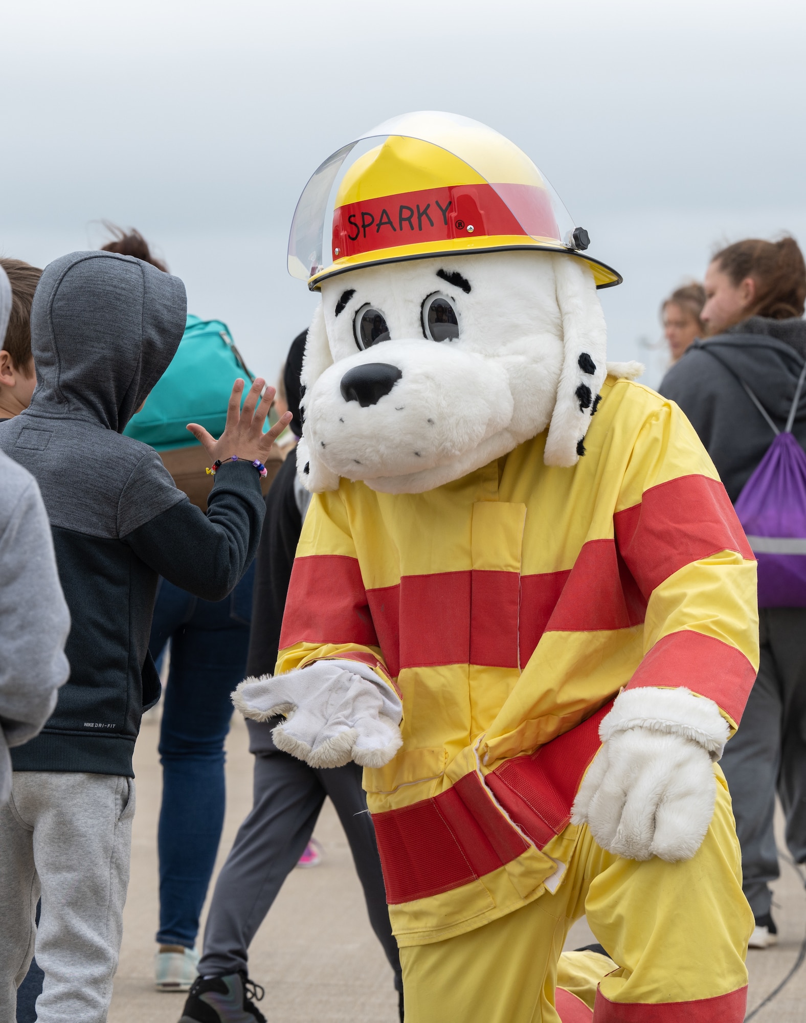 Fire protection specialists assigned to the 509th Civil Engineering Squadron conduct a training demonstration for a group of kindergarteners from Whiteman Elementary School during a base field trip on Whiteman Air Force Base, Missouri, May 4, 2022. The students toured various facilities on base receiving demonstrations from security forces and the fire department. (U.S. Air Force photo by Airman 1st Class Bryson Britt)