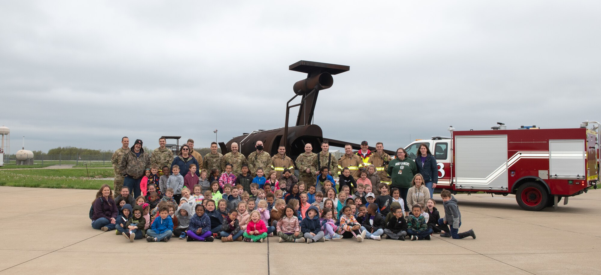 Fire protection specialists assigned to the 509th Civil Engineering Squadron conduct a training demonstration for a group of kindergarteners from Whiteman Elementary School during a base field trip on Whiteman Air Force Base, Missouri, May 4, 2022. The students toured various facilities on base receiving demonstrations from security forces and the fire department. (U.S. Air Force photo by Airman 1st Class Bryson Britt)