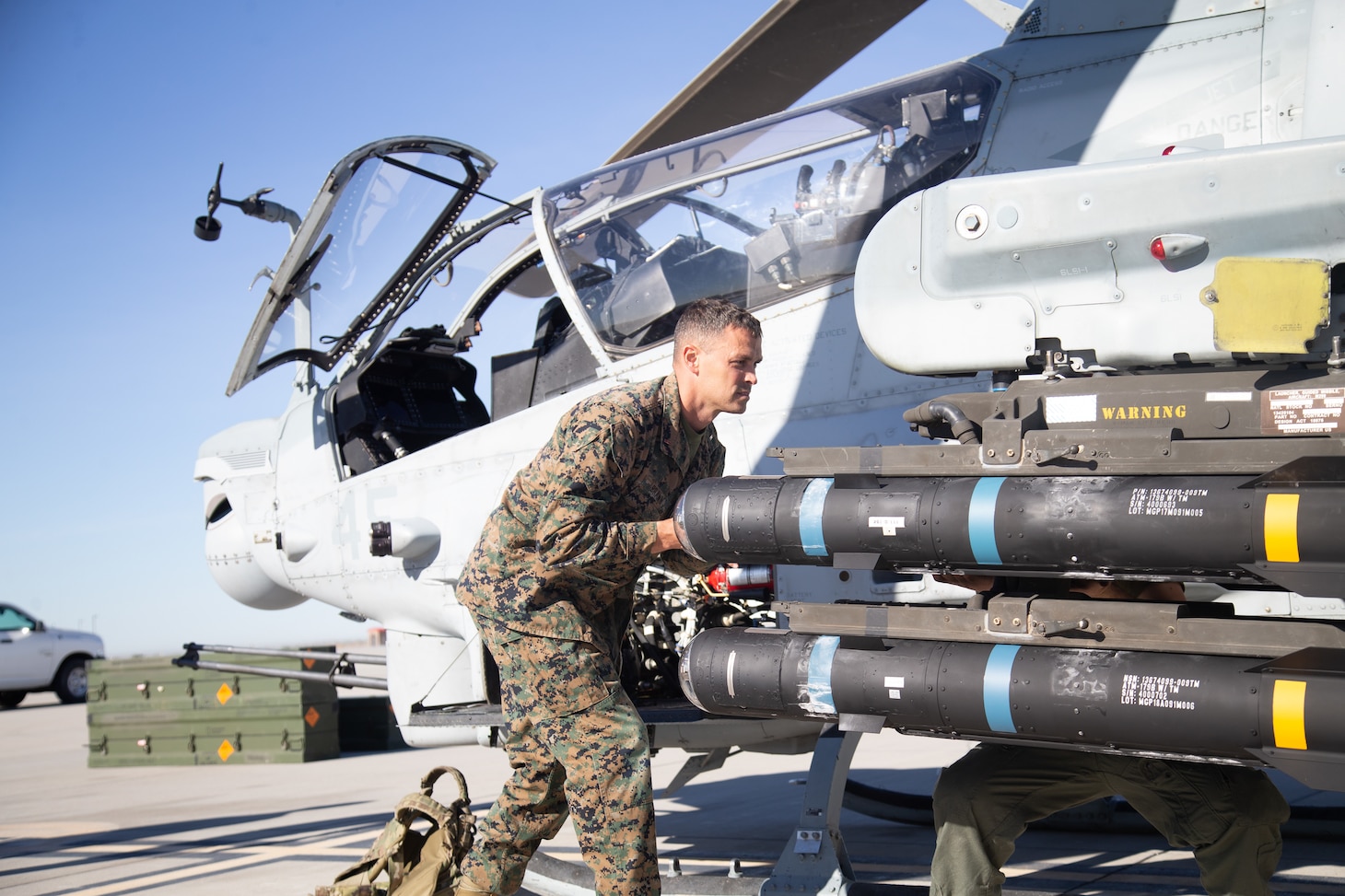 U.S. Marine Corps Chief Warrant Officer 3 Michael Brawn, aviation ordnance officer, Marine Operational Test and Evaluation Squadron 1 (VMX-1), loads a joint air-to-ground missile (JAGM) onto an AH-1Z Viper during an operational test at Marine Corps Air Station Yuma, Arizona, Dec. 6, 2021. VMX-1 fired and evaluated the JAGM to determine its suitability and effectiveness to support expeditionary advanced base operations, such as conducting strike and Close Air Support Missions.