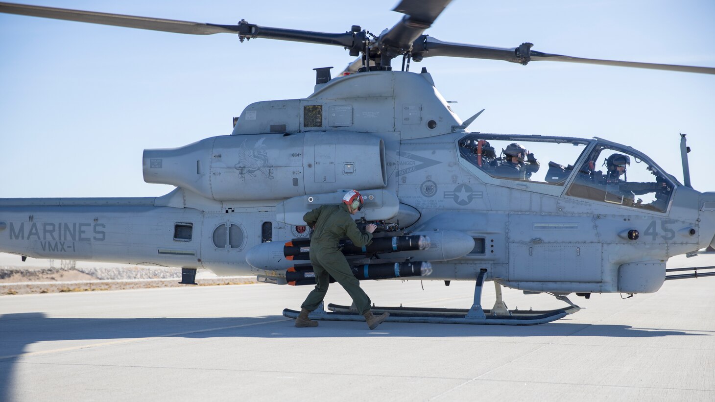 A U.S. Marine with Marine Operational Test and Evaluation Squadron One (VMX-1) arms a joint air-to-ground missile (JAGM) before take-off at Marine Corps Air Station Yuma, Ariz., Dec. 6, 2021. VMX-1 fired and evaluated the JAGM to determine its suitability and effectiveness to support expeditionary advanced base operations, such as conducting strike operations or air and missile defense.