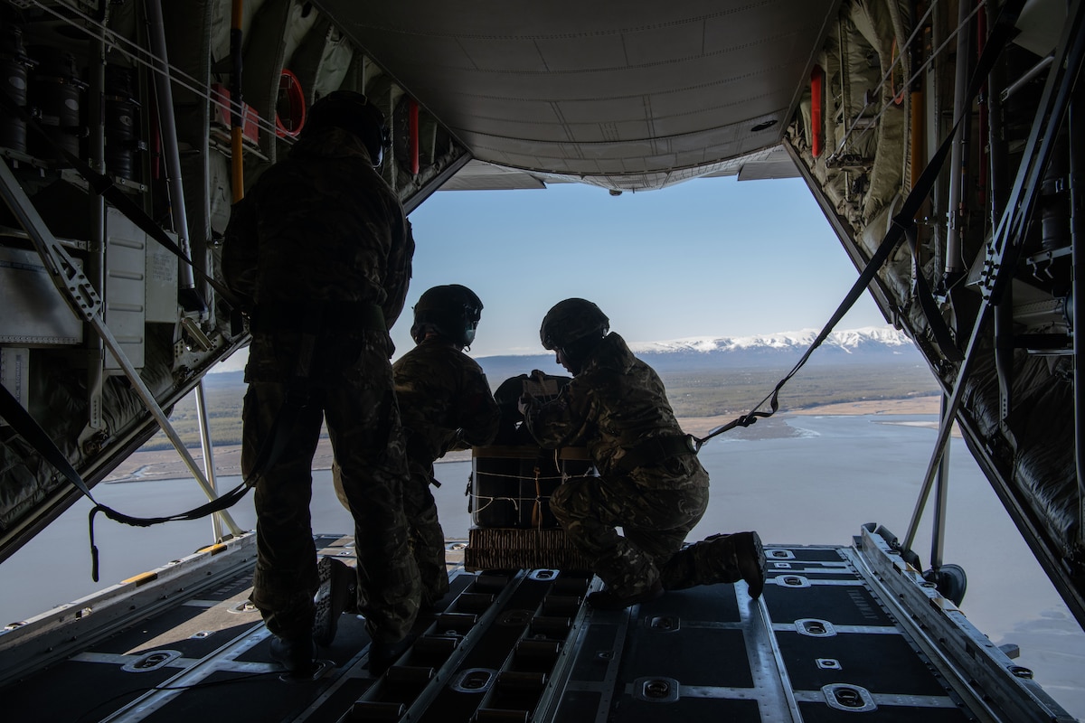 British Army soldiers conduct an air drop out of a Royal Air Force C-130J Hercules assigned to No. 47 Squadron, RAF Brize Norton, United Kingdom, during RED FLAG-Alaska 22-1 over Joint Base Elmendorf-Richardson, Alaska, May 10, 2022. RF-A is a Pacific Air Forces-directed field training exercise, allowing forces to practice interoperability by providing unique opportunities to integrate into joint and multilateral training. (U.S. Air Force photo by Senior Airman Emily Farnsworth)