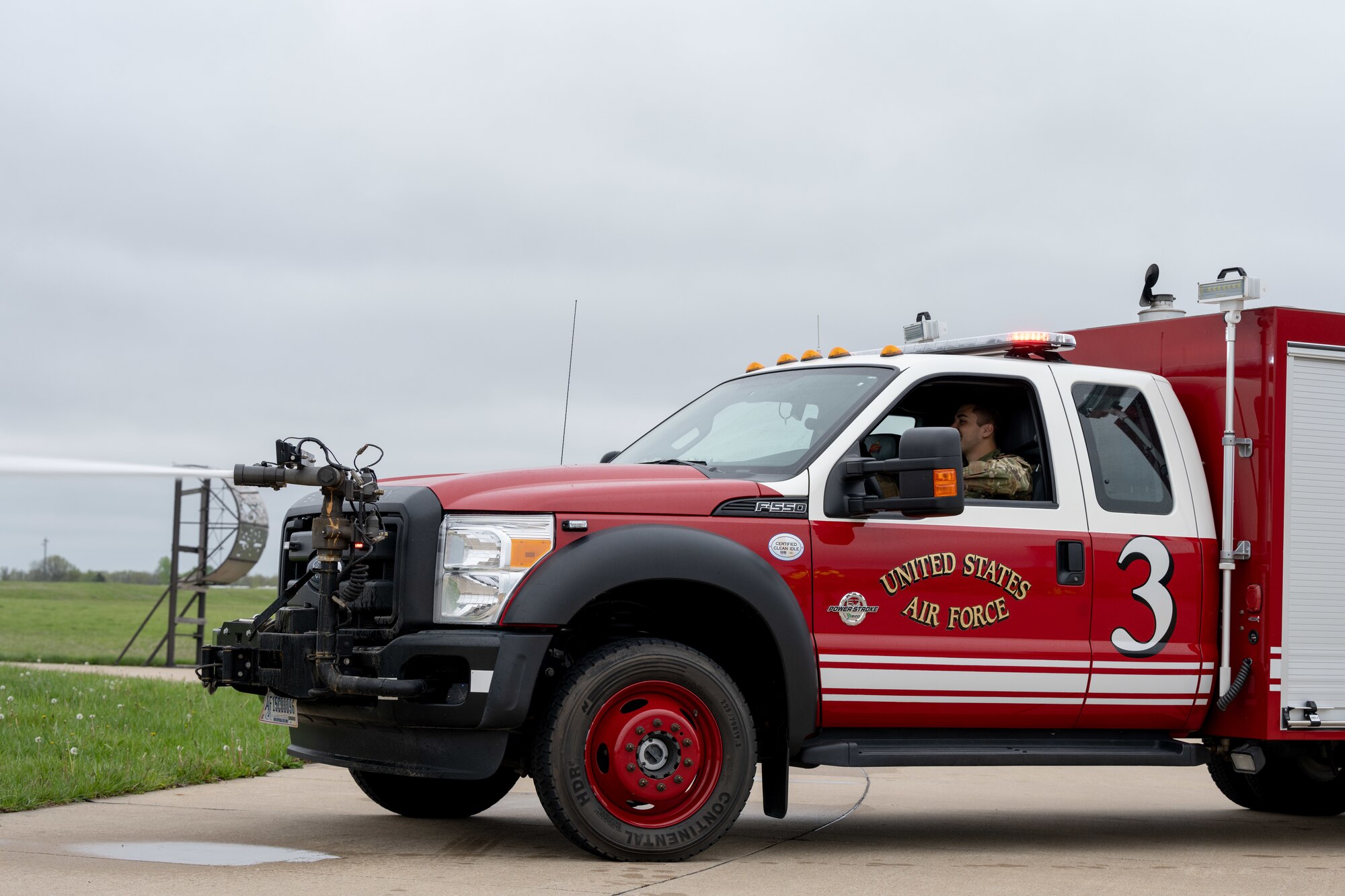 Fire protection specialists assigned to the 509th Civil Engineering Squadron conduct a training demonstration for a group of kindergarteners from Whiteman Elementary School during a base field trip on Whiteman Air Force Base, Missouri, May 4, 2022. The students toured various facilities on base receiving demonstrations from security forces and the fire department. (U.S. Air Force photo by Airman 1st Class Bryson Britt)