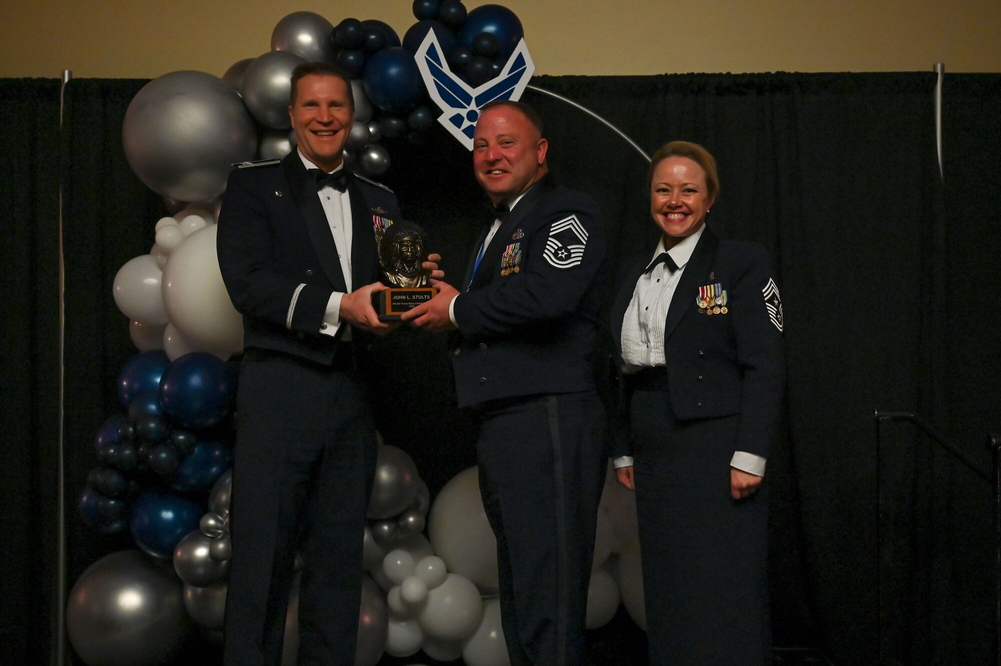 Chief Master Sgt. John Stults (center), 419th Maintenance Squadron, poses with Col. Matthew Fritz (left), 419th Fighter Wing commander, and Chief Master Sgt. Heather Richins, 419th FW command chief