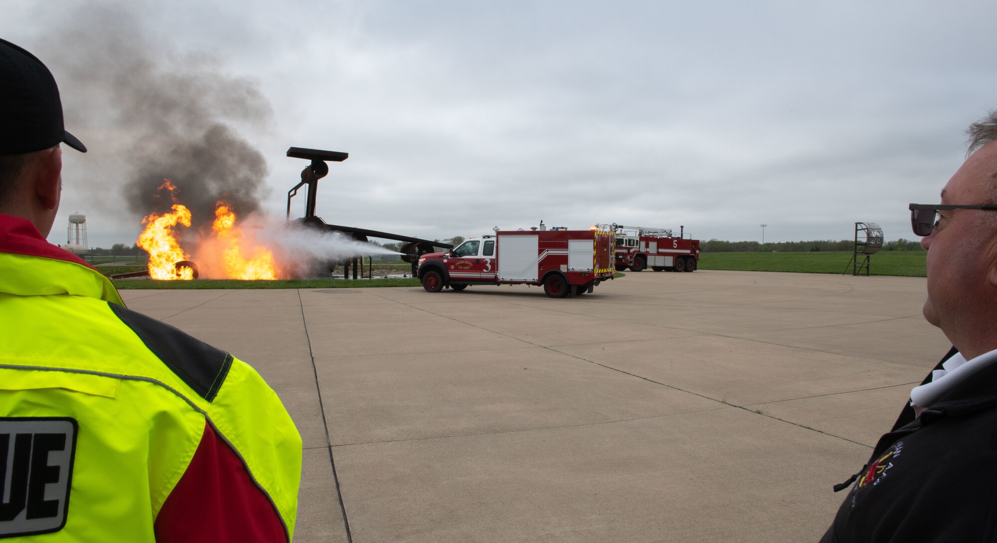 Fire protection specialists assigned to the 509th Civil Engineering Squadron conduct a training demonstration for a group of kindergarteners from Whiteman Elementary School during a base field trip on Whiteman Air Force Base, Missouri, May 4, 2022. The students toured various facilities on base receiving demonstrations from security forces and the fire department. (U.S. Air Force photo by Airman 1st Class Bryson Britt)