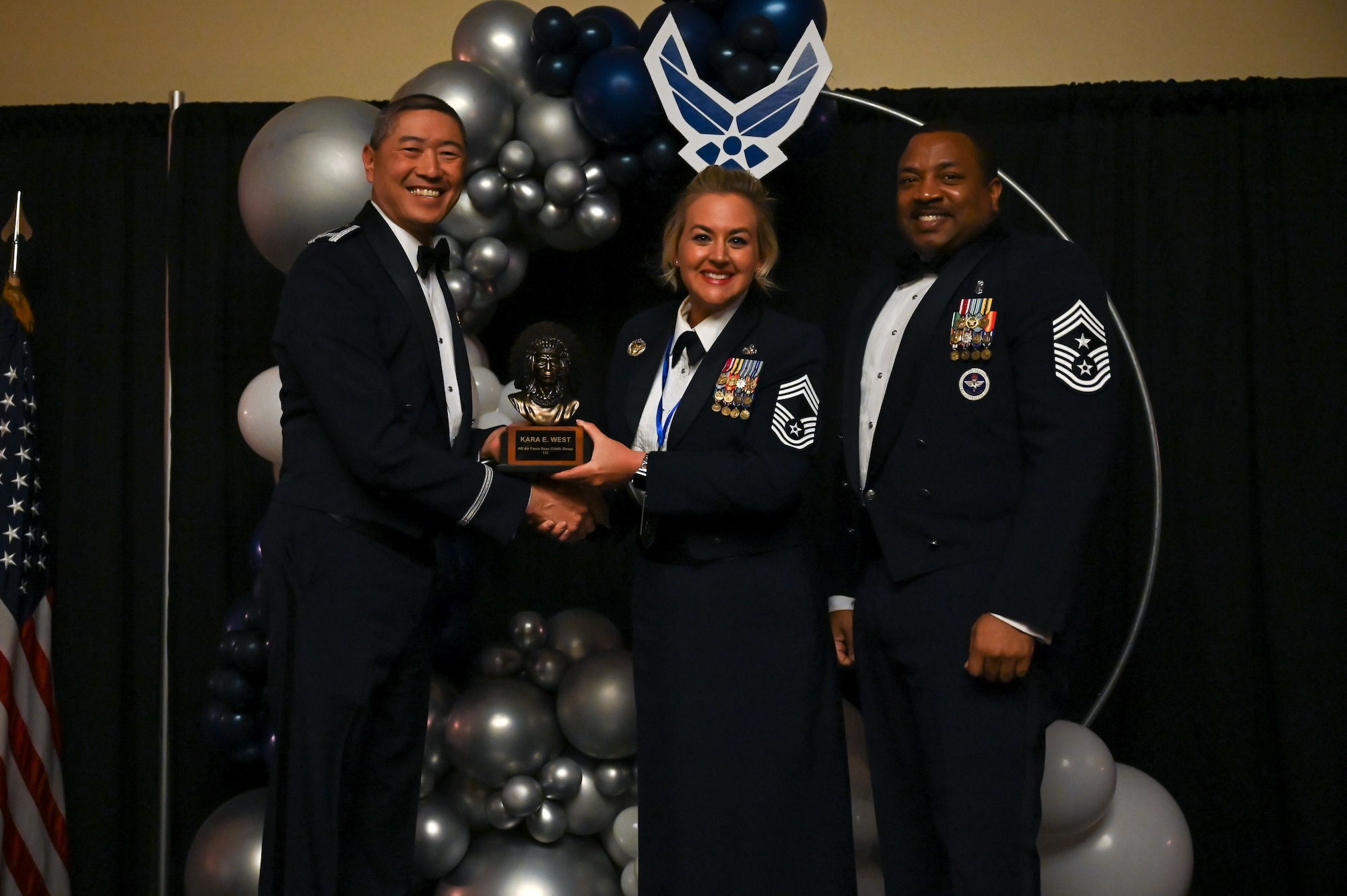 Chief Master Sgt. Kara West (center), 75th Logistics Readiness Squadron, poses with Col. Peter Feng (left), 75th Air Base Wing vice commander, and Chief Master Sgt. Raymond Riley, 75th ABW command chief.