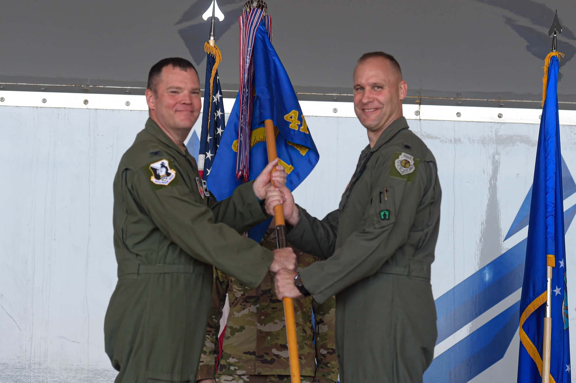 A photo of Airmen holding guidon.