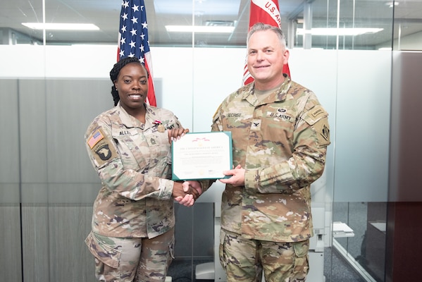 MSG Shantae Allen is presented with a Meritorious Service Medal by the U.S. Army Corps of Engineers Transatlantic Middle East District Commander, COL Philip Secrist, for her work as a contracting officer with the U.S. Army Corps of Engineers Middle East District.