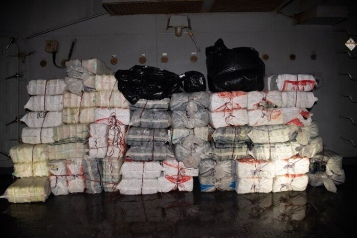 220516-N-TT059-1008 GULF OF OMAN (May 16, 2022) Bags of illegal narcotics are stacked aboard guided-missile destroyer USS Momsen (DDG 92), May 16, after being seized from a fishing vessel in the Gulf of Oman.