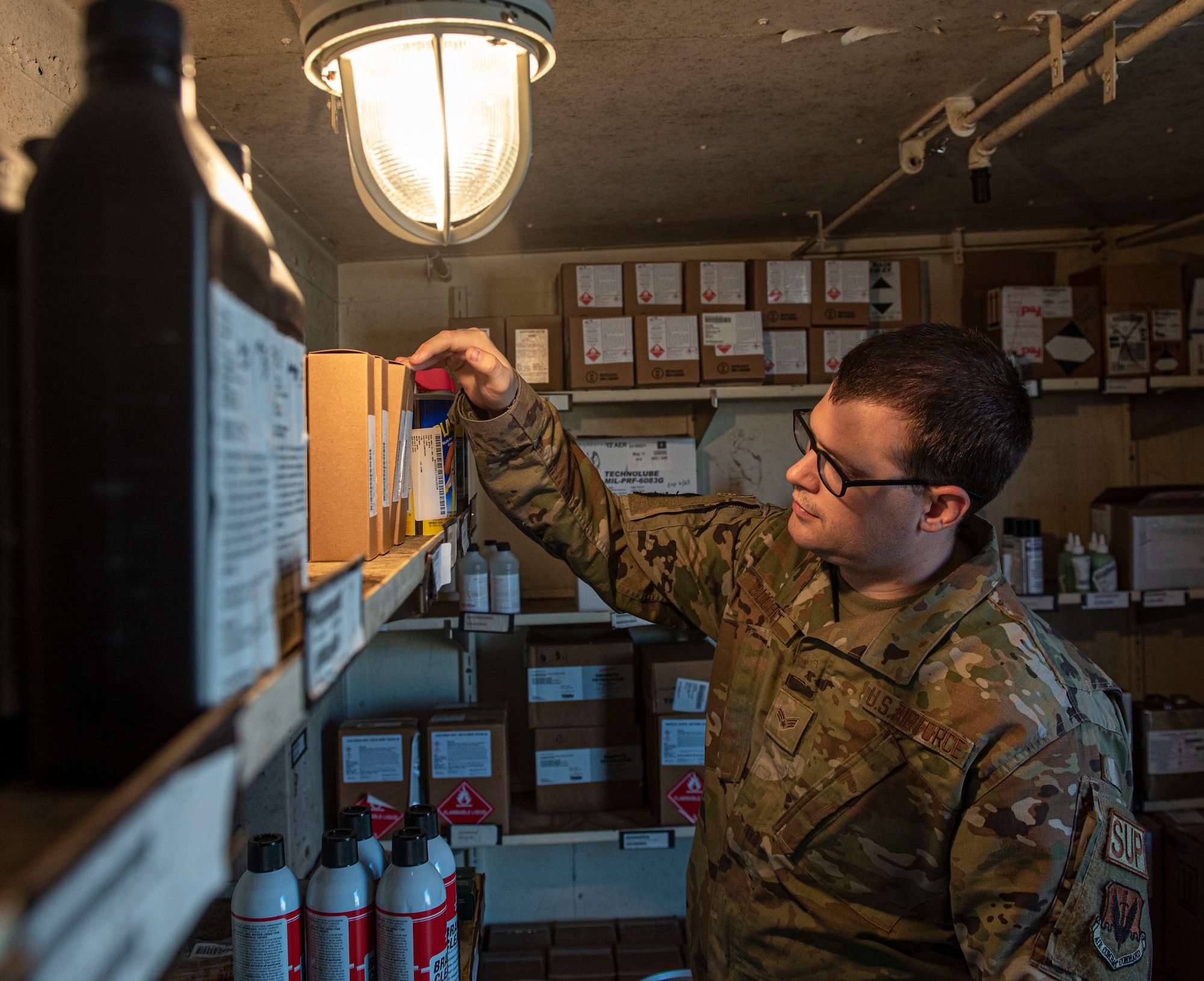 Senior Airman Dylan Buchheit, 4th Logistics Readiness Squadron material management journeyman, puts materials into storage at Seymour Johnson Air Force Base, North Carolina, May 17, 2022. The hazardous material shop has temperature-set storage units to keep substances from becoming less effective or from expiring. (U.S. Air Force photo by Airman 1st Class Sabrina Fuller)