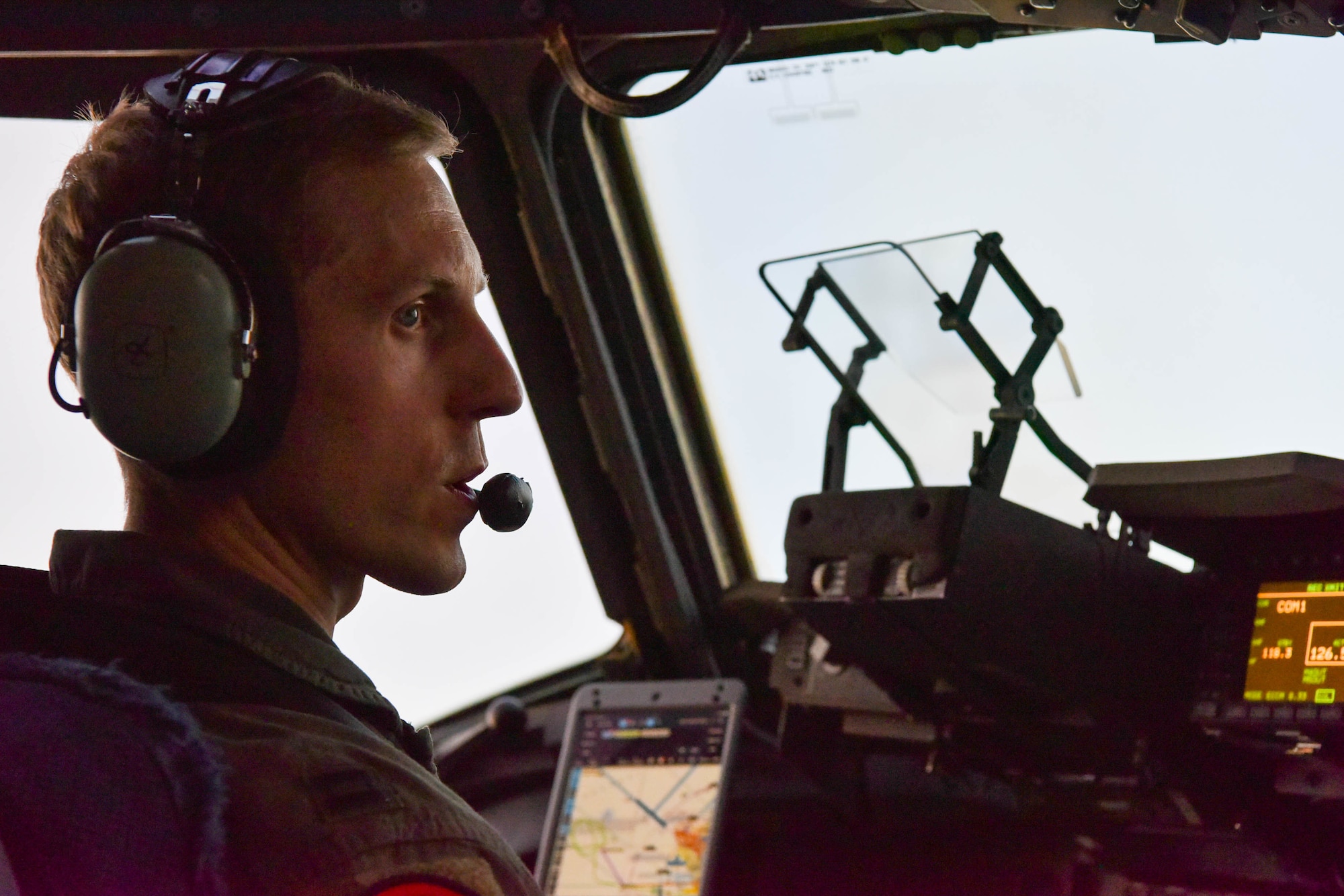 U.S. Air Force Capt. Christopher Abrahamsen, 535th Airlift Squadron instructor pilot, talks with a co-pilot in the cockpit of a C-17 Globemaster III during Exercise Global Dexterity at Joint Base Pearl Harbor-Hickam, Hawaii, May 5, 2022. The 15th Wing invited the Royal Australian Air Force No. 36 Squadron to join in a bilateral C-17-focused exercise to better increase interoperability for future Indo-Pacific operations. (U.S. Air Force photo by Airman 1st Class Makensie Cooper)