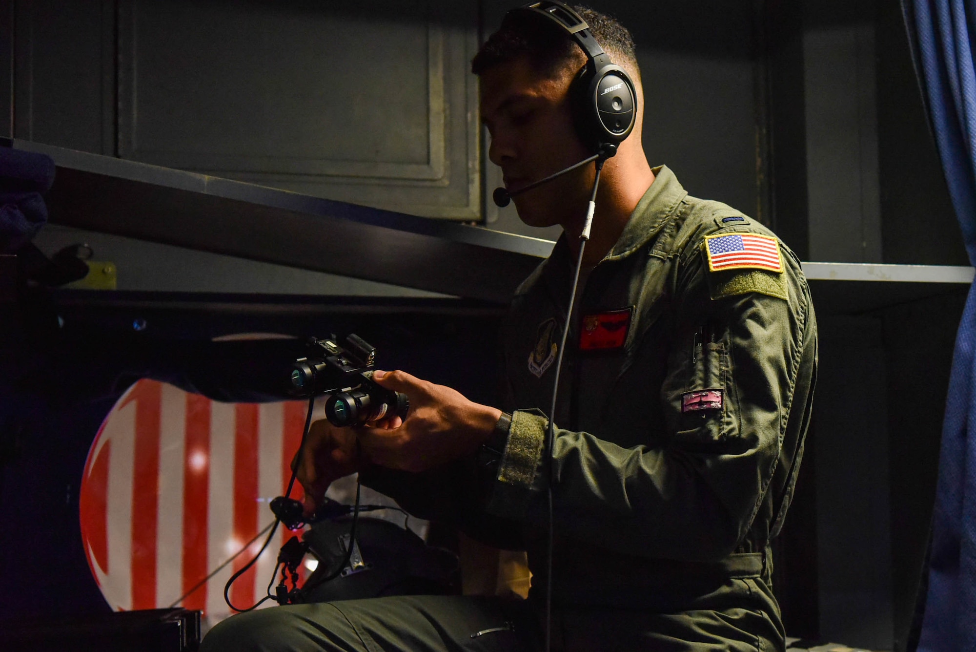 U.S. Air Force 1st Lt. Marcus Pryor, 535th Airlift Squadron pilot, prepares night vision goggles for nighttime flying during Exercise Global Dexterity at Joint Base Pearl Harbor-Hickam, Hawaii, May 5, 2022. The Royal Australian Air Force joined the 535th Airlift Squadron for flare demonstrations and nighttime training aerial maneuvers around the Hawaiian Islands to better increase each crews' operational resiliency. (U.S. Air Force photo by Airman 1st Class Makensie Cooper)