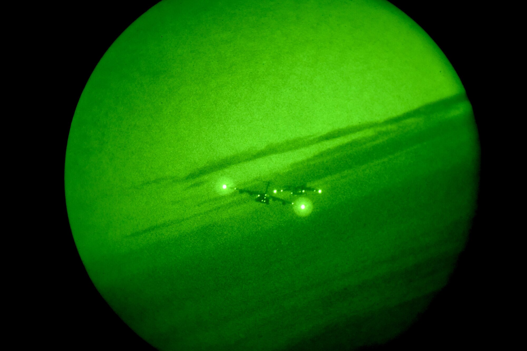 A U.S. Air Force C-17 Globemaster III flies alongside a Royal Australian Air Force C-17 in formation over the Pacific Ocean at night as part of Exercise Global Dexterity 2022 at Joint Base Pearl Harbor-Hickam, Hawaii, May 5, 2022. The RAAF squadron visited JBPHH to join both active duty and National Guard C-17s for training missions around the Hawaiian Islands to develop tactical airlift and airdrop capabilities. (U.S. Air Force photo by Airman 1st Class Makensie Cooper)