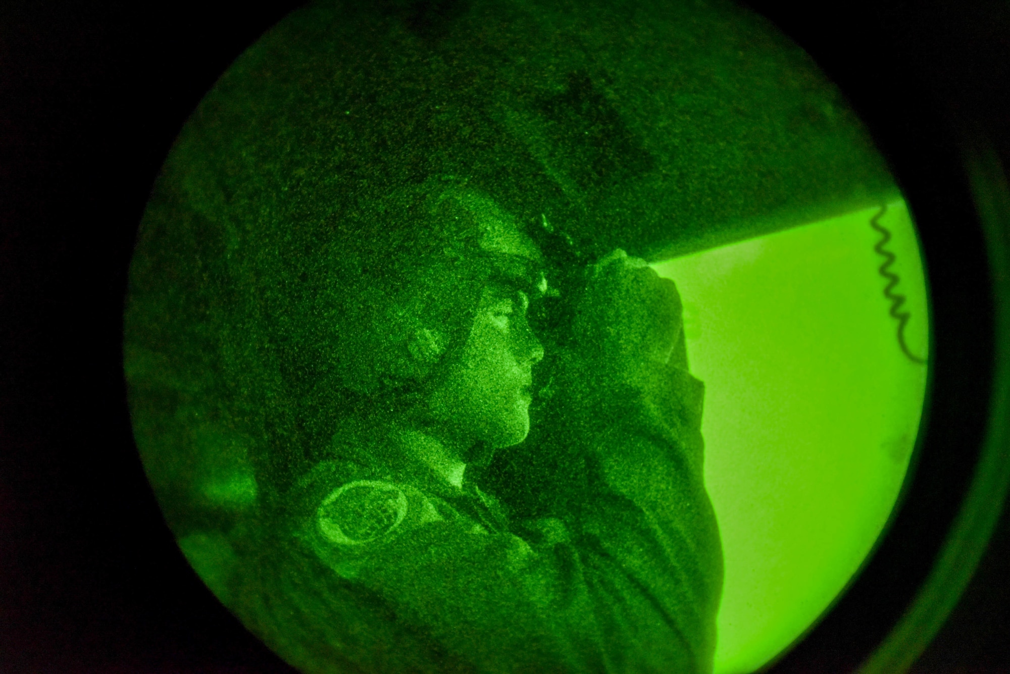 U.S. Air Force Capt. Philip Conte, 535th Airlift Squadron pilot, looks through a pair of night vision goggles during Exercise Global Dexterity 2022 at Joint Base Pearl Harbor-Hickam, Hawaii, May 5, 2022. Exercise Global Dexterity included side-by-side training of C-17s from the U.S. Air Force, Hawaii Air National Guard, and the Royal Australian Air Force to better develop tactics between the three forces. (U.S. Air Force photo by Airman 1st Class Makensie)