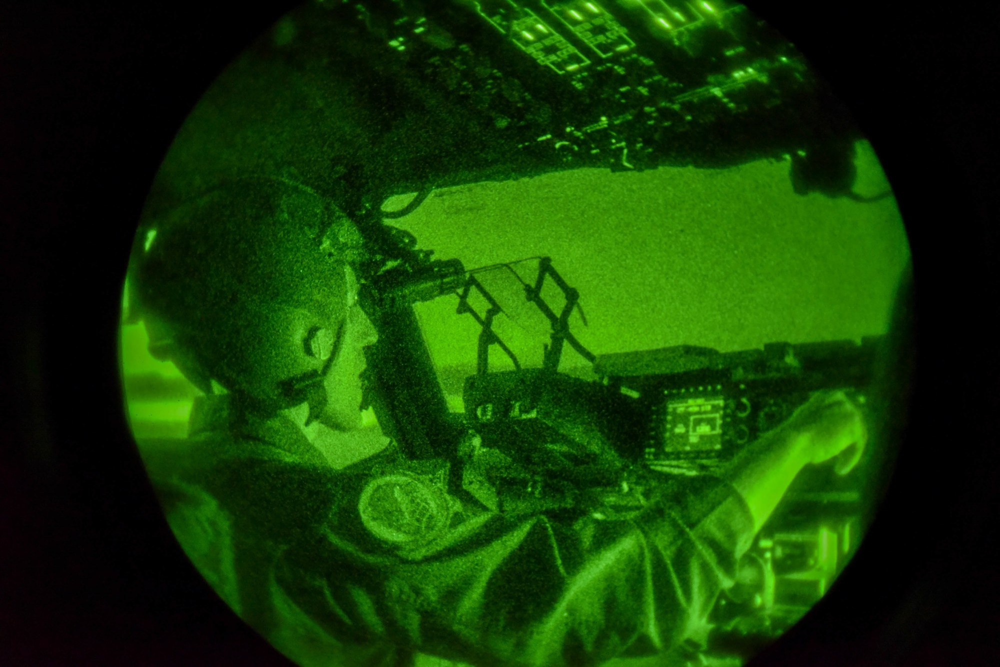U.S. Air Force Capt. Christopher Abrahamsen, 535th Airlift Squadron instructor pilot, flies a C-17 Globemaster III during the night with the assistance of night vision goggles during Exercise Global Dexterity at Joint Base Pearl Harbor-Hickam, Hawaii, May 5, 2022. The 15th Wing invited the Royal Australian Air Force No. 36 Squadron to join in a bilateral C-17 focused exercise to better increase interoperability for future Indo-Pacific operations. (U.S. Air Force photo by Airman 1st Class Makensie Cooper)