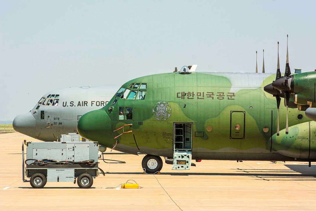 Two large aircraft sit parked side by side.