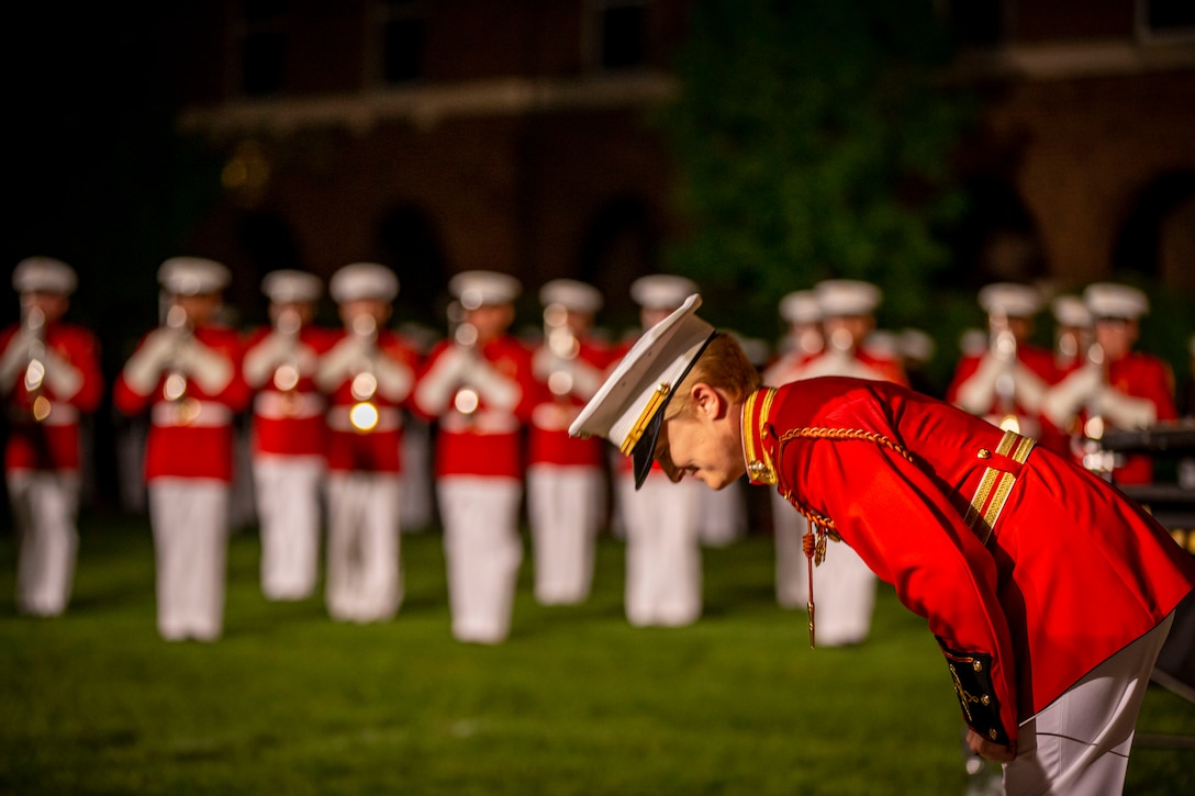 Chief Warrant Officer 2 Courtney Lawrence, director, “The Commandant’s Own,” U.S. Marine Drum and Bugle Corps, bows after a performance during a Friday Evening Parade at Marine Barracks Washington, D.C., May 13, 2022.  The hosting official was Gen. Eric Smith, the 36th Assistant Commandant of the Marine Corps, and the guests of honor were Gen. Thomas R. Morgan (Ret.), 21st Assistant Commandant of the Marine Corps, Gen. Walter E. Boomer (Ret.), 24th Assistant Commandant of the Marine Corps, Gen. Terrence Dake (Ret.), 27th Assistant Commandant of the Marine Corps, Gen. Robert Magnus (Ret.), 30th Assistant Commandant of the Marine Corps, Gen. John M. Paxton Jr (Ret.), 33rd Assistant Commandant of the Marine Corps. (U.S. Marine Corps photo by Cpl. Mark Morales)