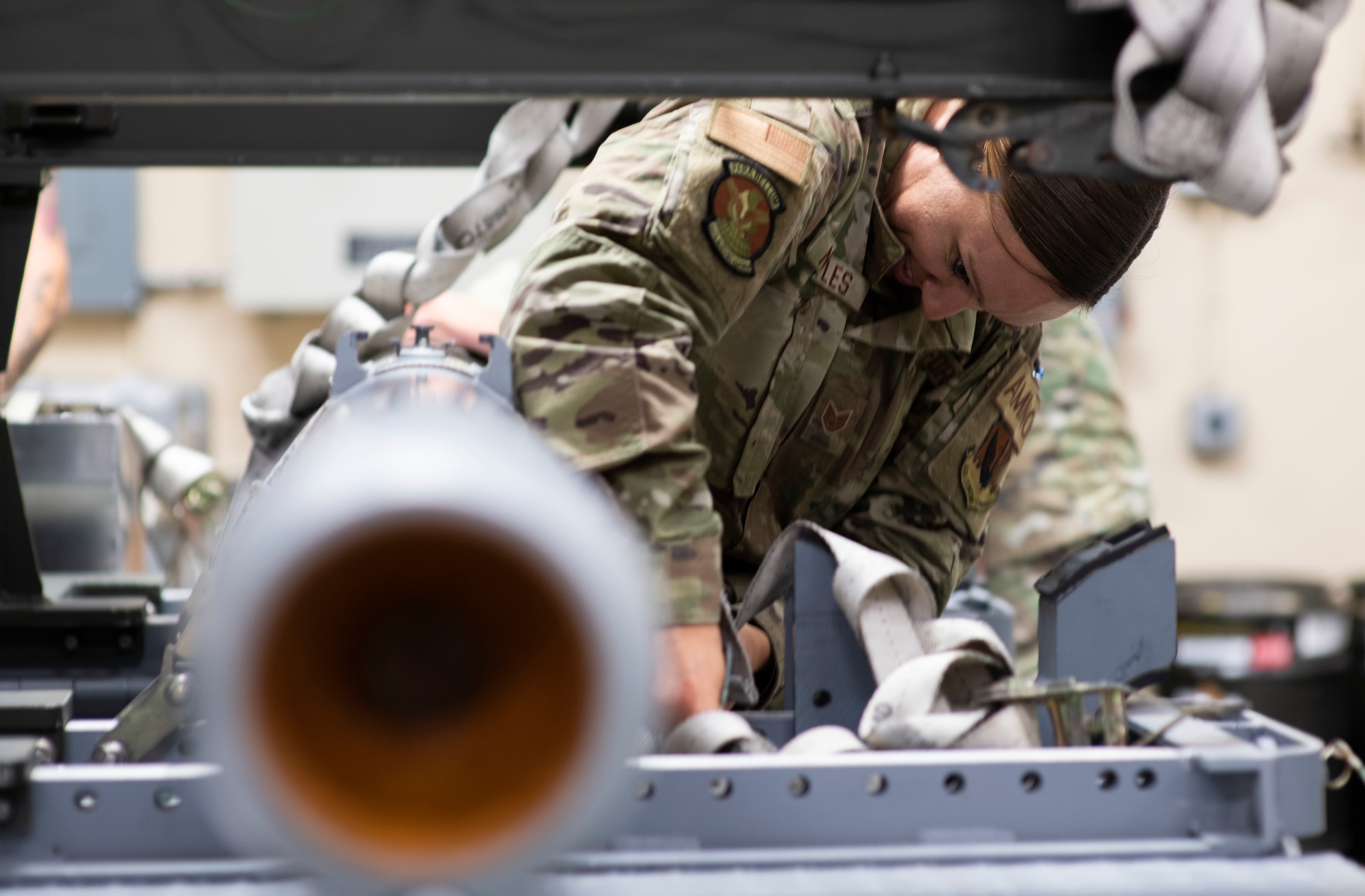 U.S. Air Force Staff Sgt. Jacqueline Nettles, 325th Munitions Squadron production supervisor, ensures munitions are securely strapped to a munitions handling trailer at Tyndall Air Force Base, Florida, May 10, 2022.