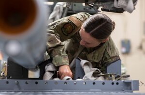 U.S. Air Force Staff Sgt. Jacqueline Nettles, 325th Munitions Squadron production supervisor, ensures munitions are securely strapped to a munitions handling trailer at Tyndall Air Force Base, Florida, May 10, 2022.