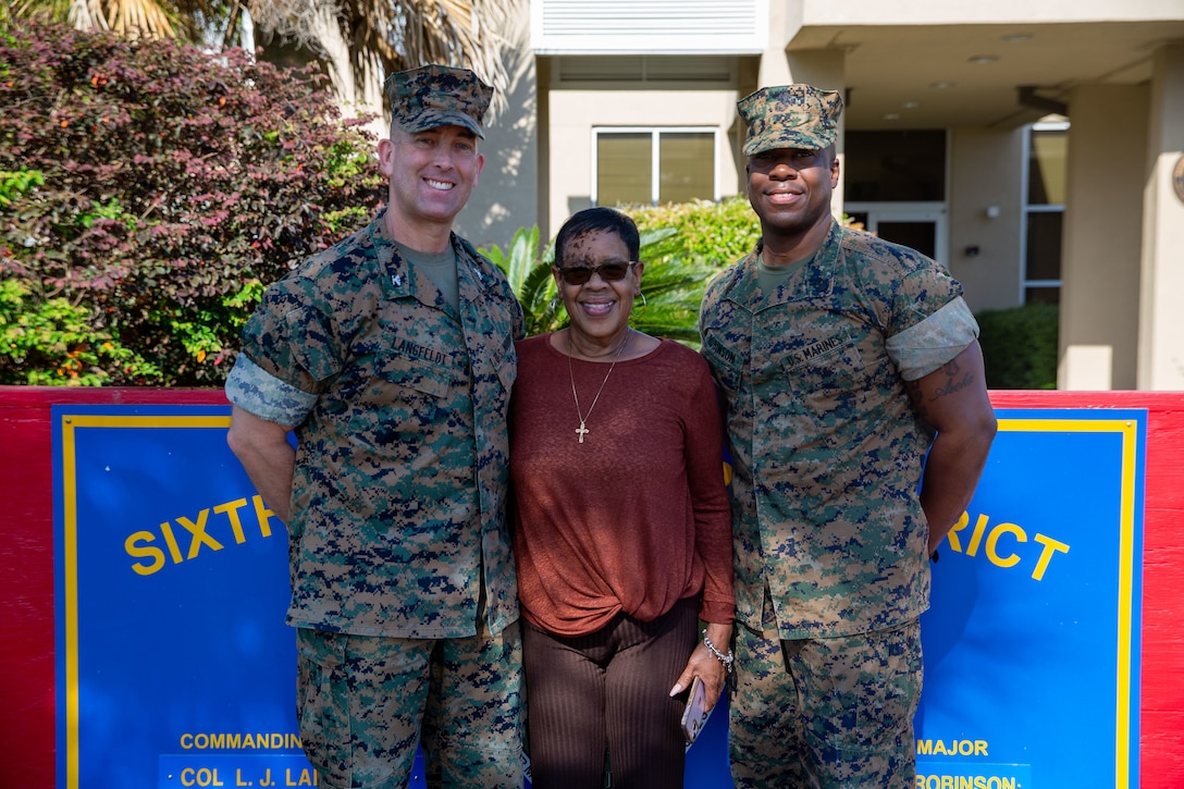 U.S. Marine Corps Col. Lance J. Langfeldt, 6th Marine Corps District commanding officer, left, and Sgt. Maj. Frank O. Robinson, the 6MCD sergeant major, right, congratulate Sandra Blackmon, the command secretary for 6MCD,  for earning the Pacesetter Award at Marine Corps Recruit Depot Parris Island, South Carolina, April 26, 2022. Blackmon was recognized publicly for her exceptional contributions in support of the district's mission as the command secretary for 6MCD.