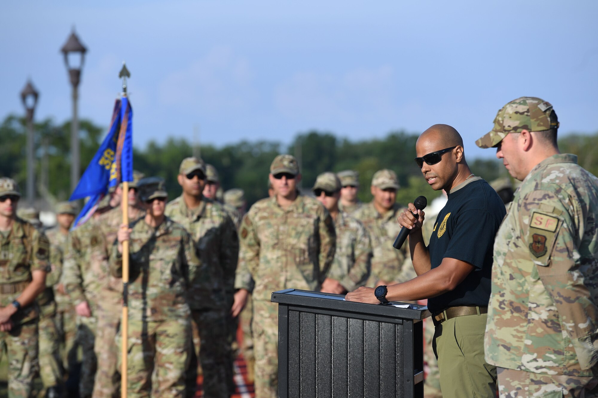 U.S. Air Force Special Agent Shannon Robinson, Office of Special Investigations Detachment 407 commander, reads the names of fallen law enforcement members during the Police Week ruck march on the triangle track at Keesler Air Force Base, Mississippi, May 16, 2022. The event was held during National Police Week, recognizing the men and women in law enforcement. (U.S. Air Force photo by Kemberly Groue)