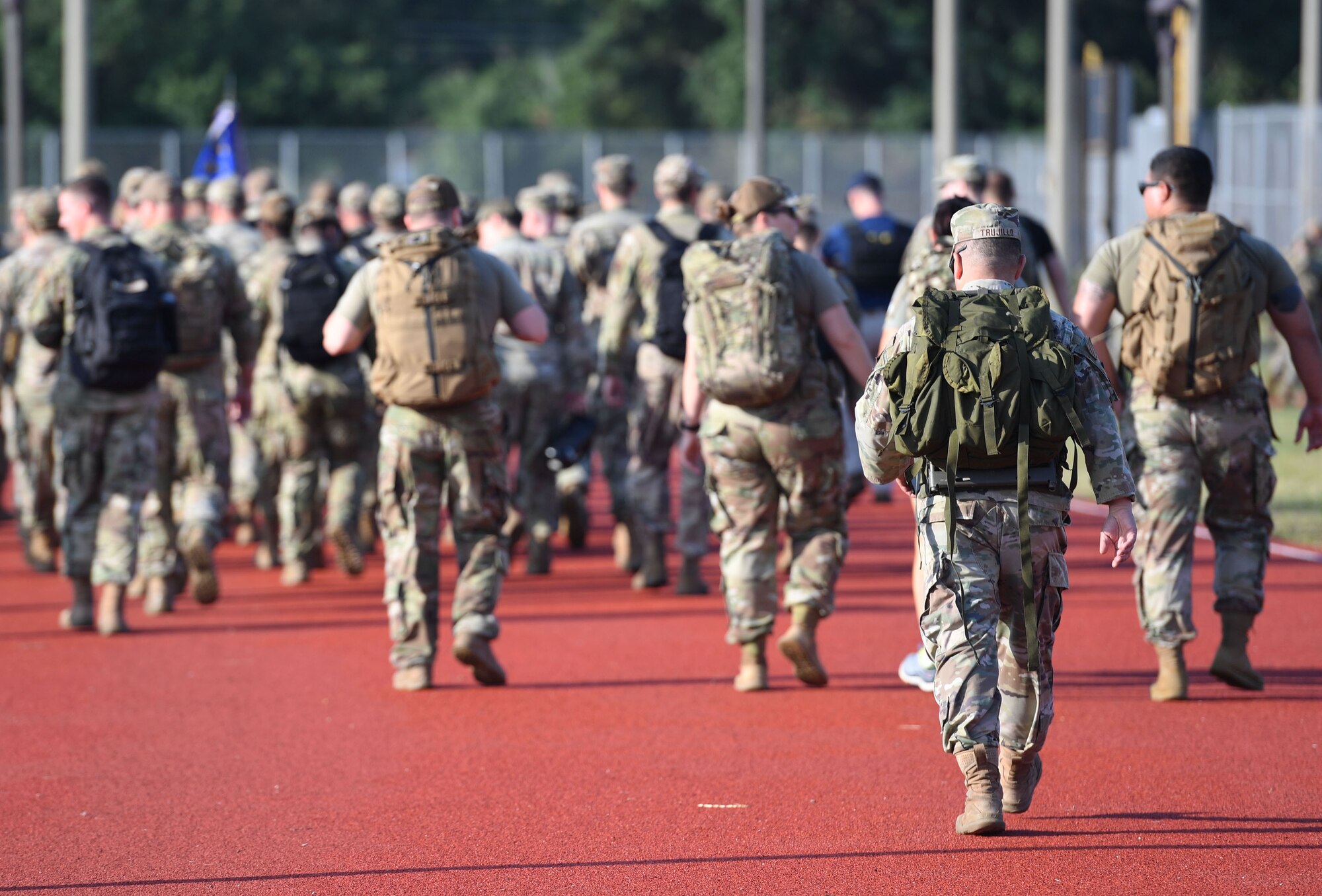Keesler personnel participate in the Police Week ruck march on the triangle track at Keesler Air Force Base, Mississippi, May 16, 2022. The event was held during National Police Week, recognizing the men and women in law enforcement. (U.S. Air Force photo by Kemberly Groue)
