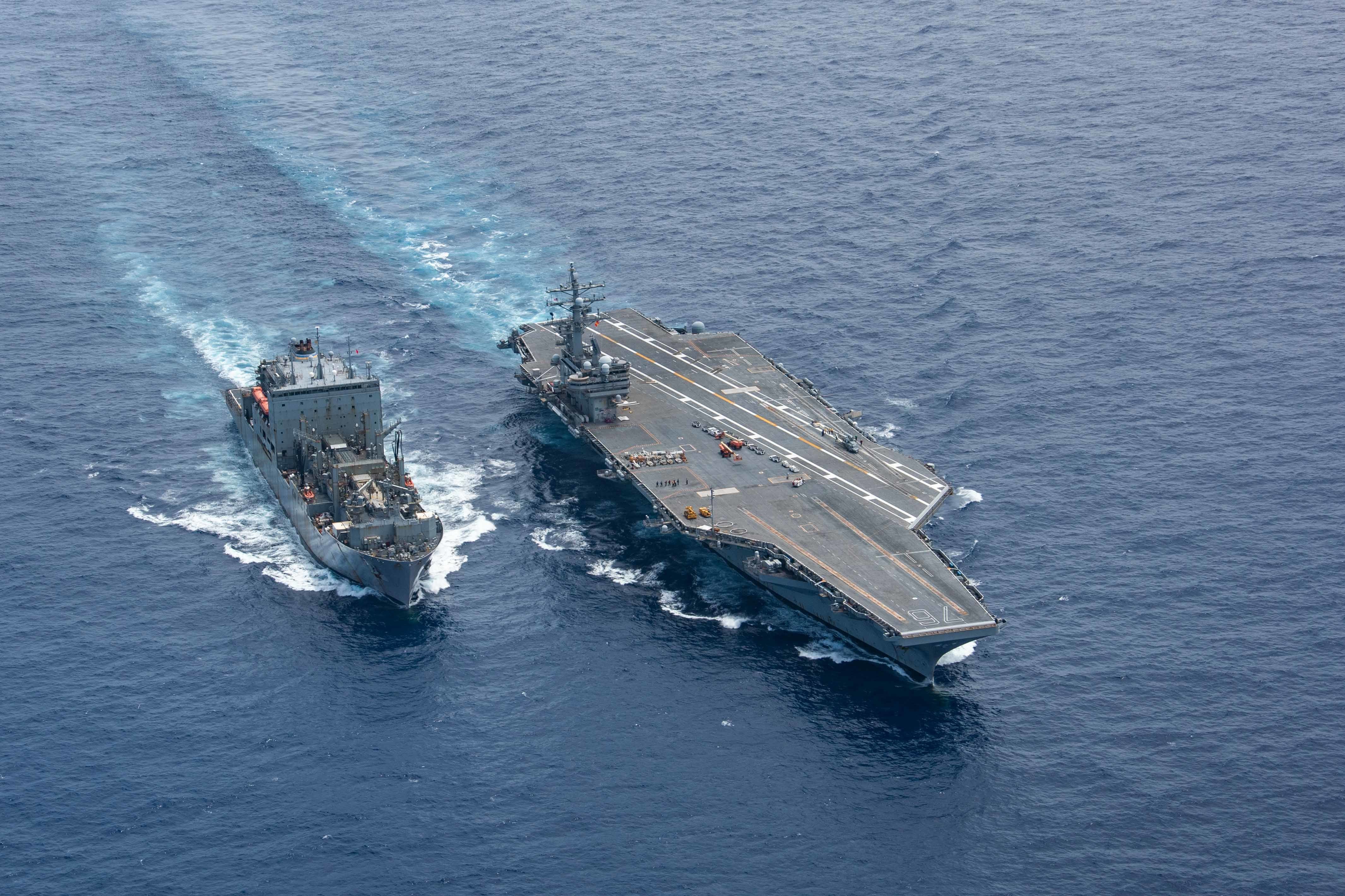 USS Ronald Reagan (CVN 76) steams alongside the Military Sealift Command dry cargo and ammunition ship USNS Amelia Earhart (T-AKE 6) during a replenishment-at-sea.
