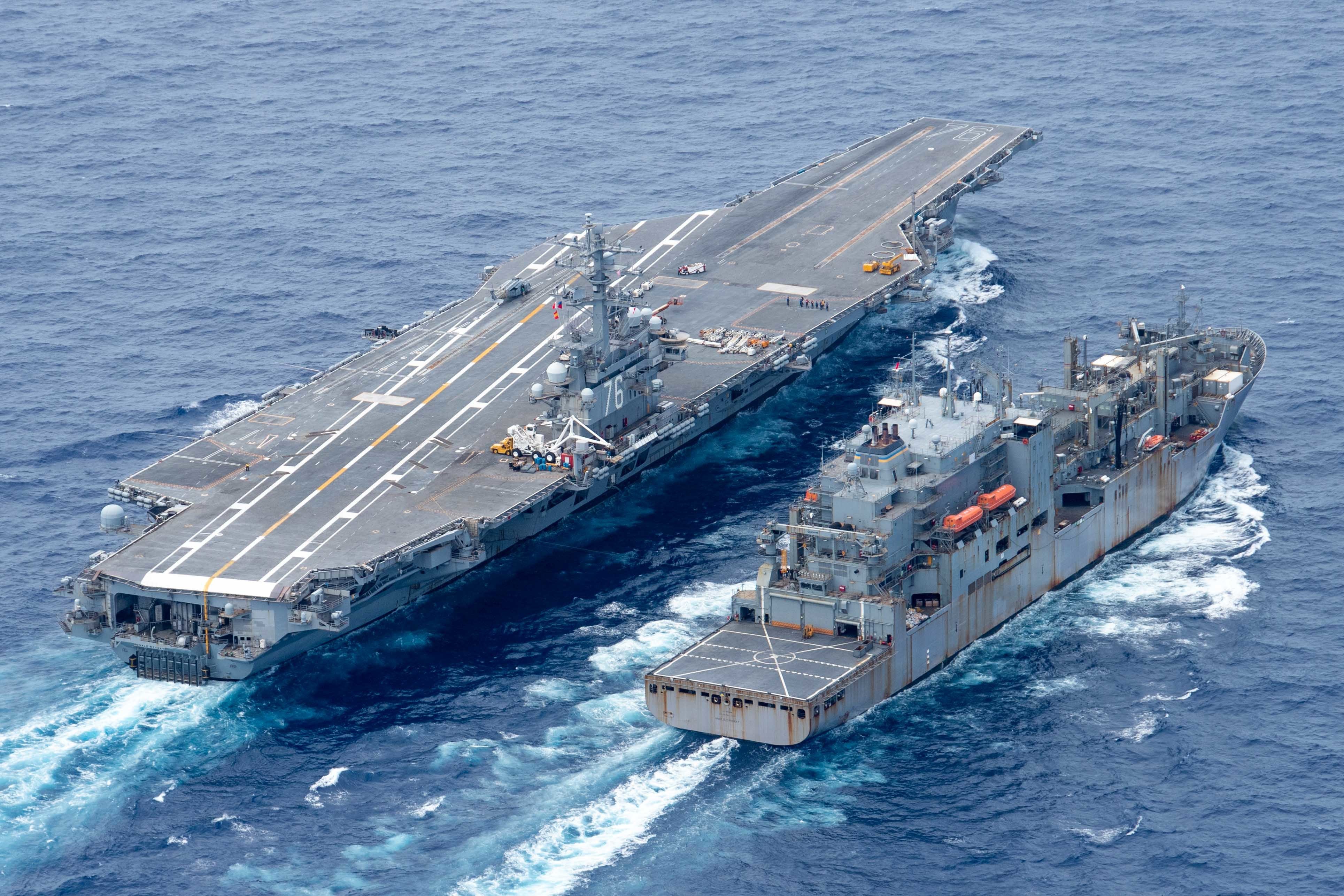 The U.S. Navy's only forward-deployed aircraft carrier USS Ronald Reagan (CVN 76) steams alongside the Military Sealift Command dry cargo and ammunition ship USNS Amelia Earhart (T-AKE 6) during a replenishment-at-sea.