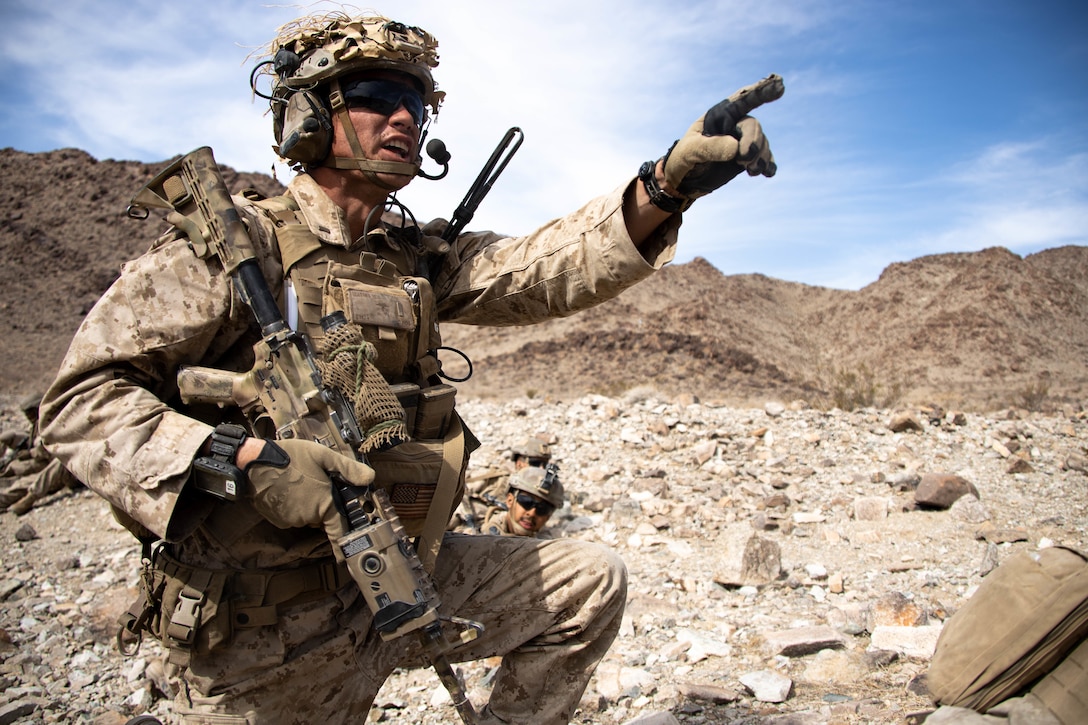 U.S. Marine Corps 2nd Lt. William Mathis, an infantry officer with India Company, 3d Battalion, 1st Marine Regiment, 1st Marine Division, relays a command while conducting Range 400 as a part of Integrated Training Exercise (ITX) 3-22 at Marine Corps Air Ground Combat Center Twentynine Palms, California, April 10, 2022. ITX is a month-long training evolution comprised of multiple ranges to refine combined arms maneuver in offensive and defensive combat operations. (U.S. Marine Corps photo by Lance Cpl. Brayden Daniel)