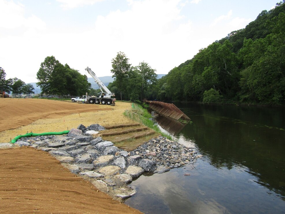 Removal of a water diversion structure used to hold the river back from excavation work along the bank.
