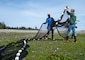 Dan Swann, left, a fisheries and marine biologist technician for Naval Facilities Engineering Systems Command Northwest, and Jake Gregg, a fish biologist for United States Geological Survey Marrowstone Marine Field Station, fold a net before redeploying it during a beach seining at Naval Magazine Indian Island in Port Hadlock, Washington April 29, 2021. The seining net is folded and carried to avoid damage from the barnacle covered beach.