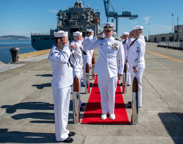 Cmdr. Andrew Crouse, incoming commanding officer, Naval Magazine Indian Island, renders a hand salute after walking through sideboys during a change of command ceremony at NMII in Port Hadlock, Washington June 24, 2021. During the ceremony, Crouse relieved Cmdr. Don Emerson as commanding officer of NMII. (U.S. Navy Photo by Mass Communication Specialist 3rd Class Emilia C. Hilliard)