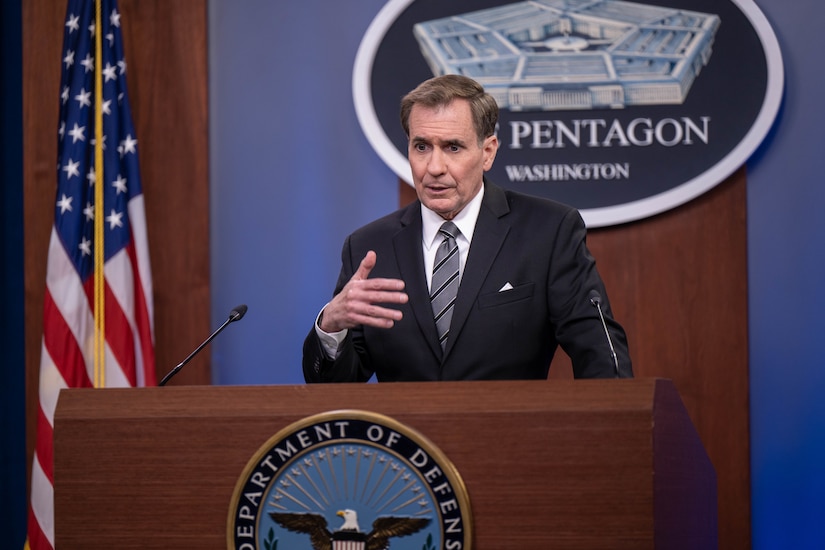 A man stands behind a lectern.