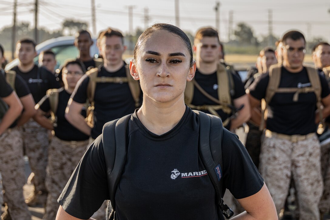 A U.S. Marine Corps officer candidate with Officer Selection Team Riverside, 12th Marine Corps District, stands at parade rest during an Officer Candidates School preparation weekend at Edson Range, Camp Pendleton, California on April 30, 2022. The OCS preparation weekend is an opportunity for the candidates to prepare and ask questions before attending OCS in Quantico, Virginia. (U.S. Marine Corps photo by Sgt. Ana S. Madrigal)