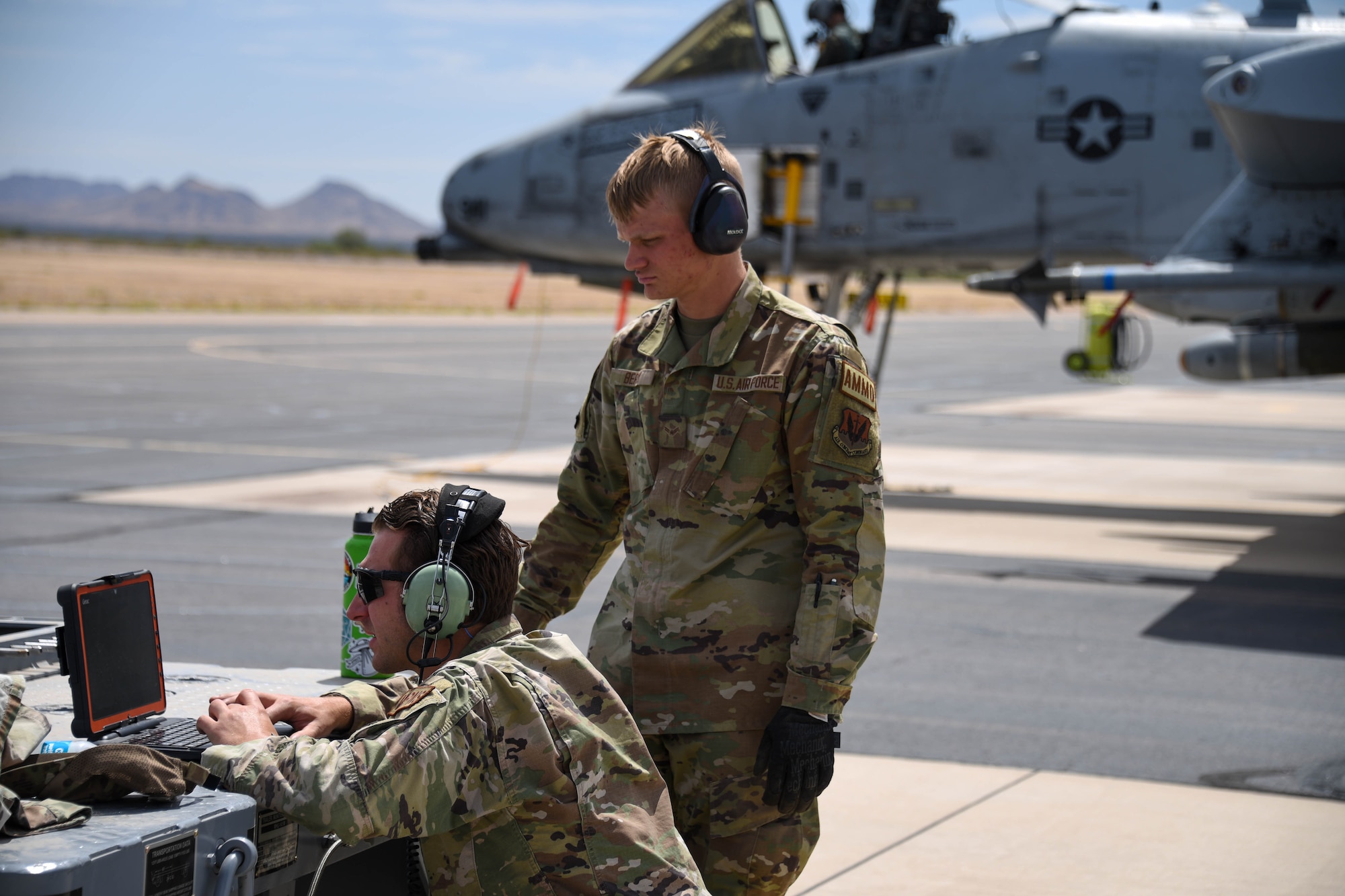 A photo of Airmen looking at a computer screen on the flight line.