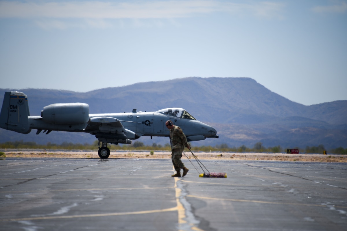 A photo of an Airman hauling supplies across the flight line.