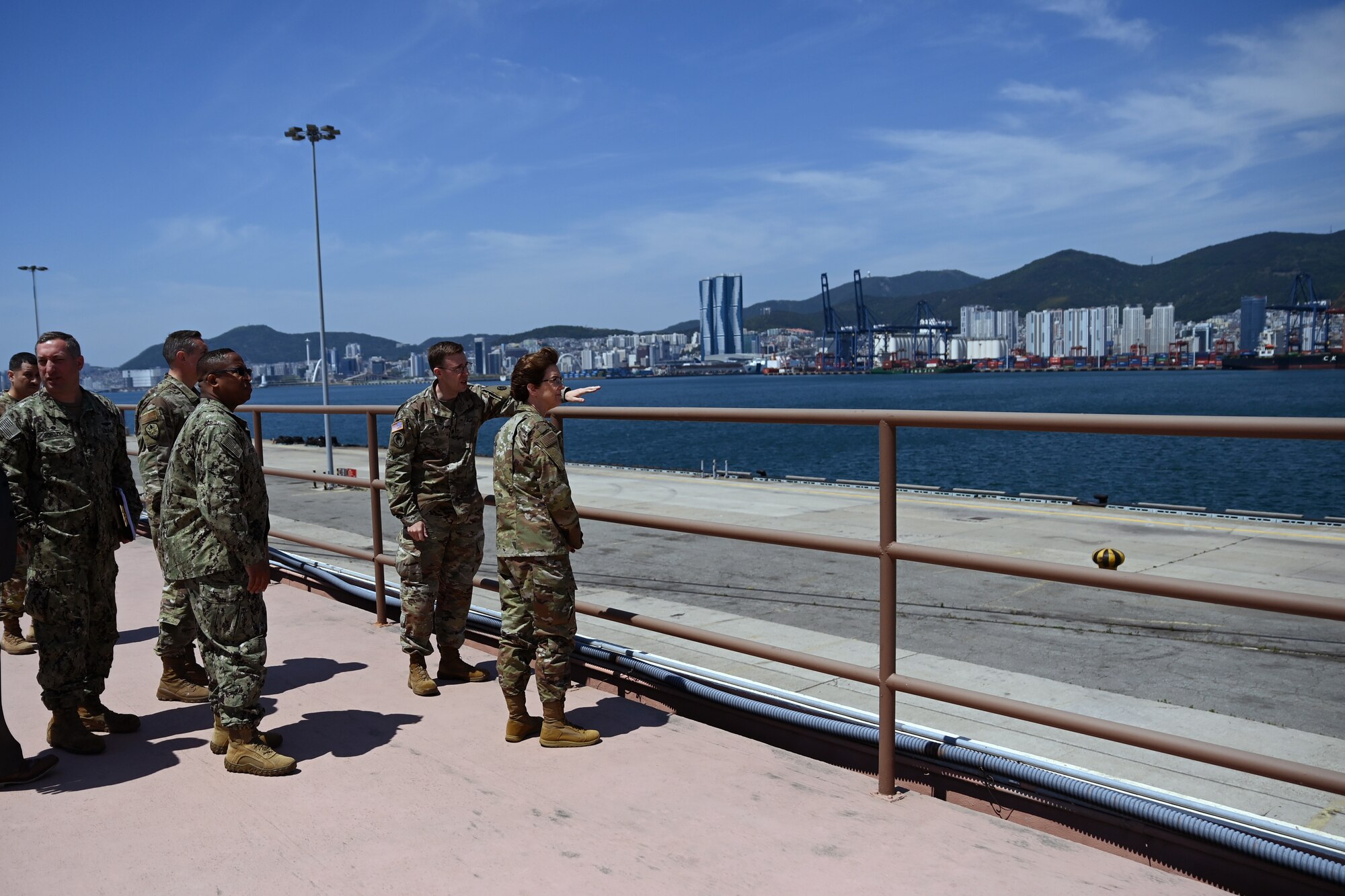 U.S. Army Lt. Col. Jamison Smith, 599th Transportation Brigade commander, briefs U.S. Air Force Gen. Jacqueline D. Van Ovost, commander, U.S. Transportation Command (USTRANSCOM), while touring the 837th Transportation Battalion May 17, 2022, Pier 8, Busan, Republic of Korea. Every operation the Joint Force participates in starts and ends with USTRANSCOM. (U.S. Air Force photo by Master Sgt. Rachelle Morris)
