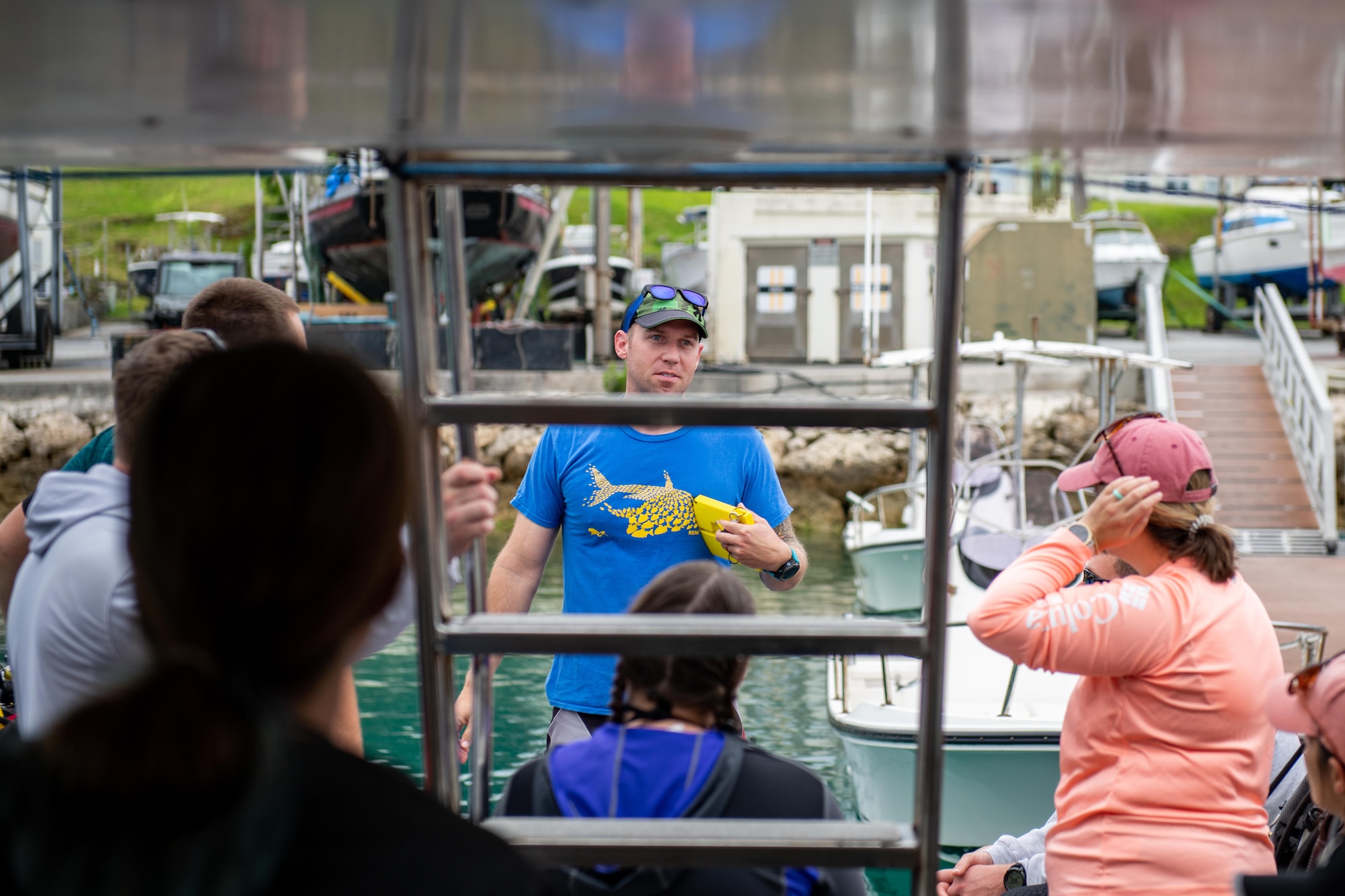 The ships divemaster gives a safety brief on the main deck of the boat before casting off