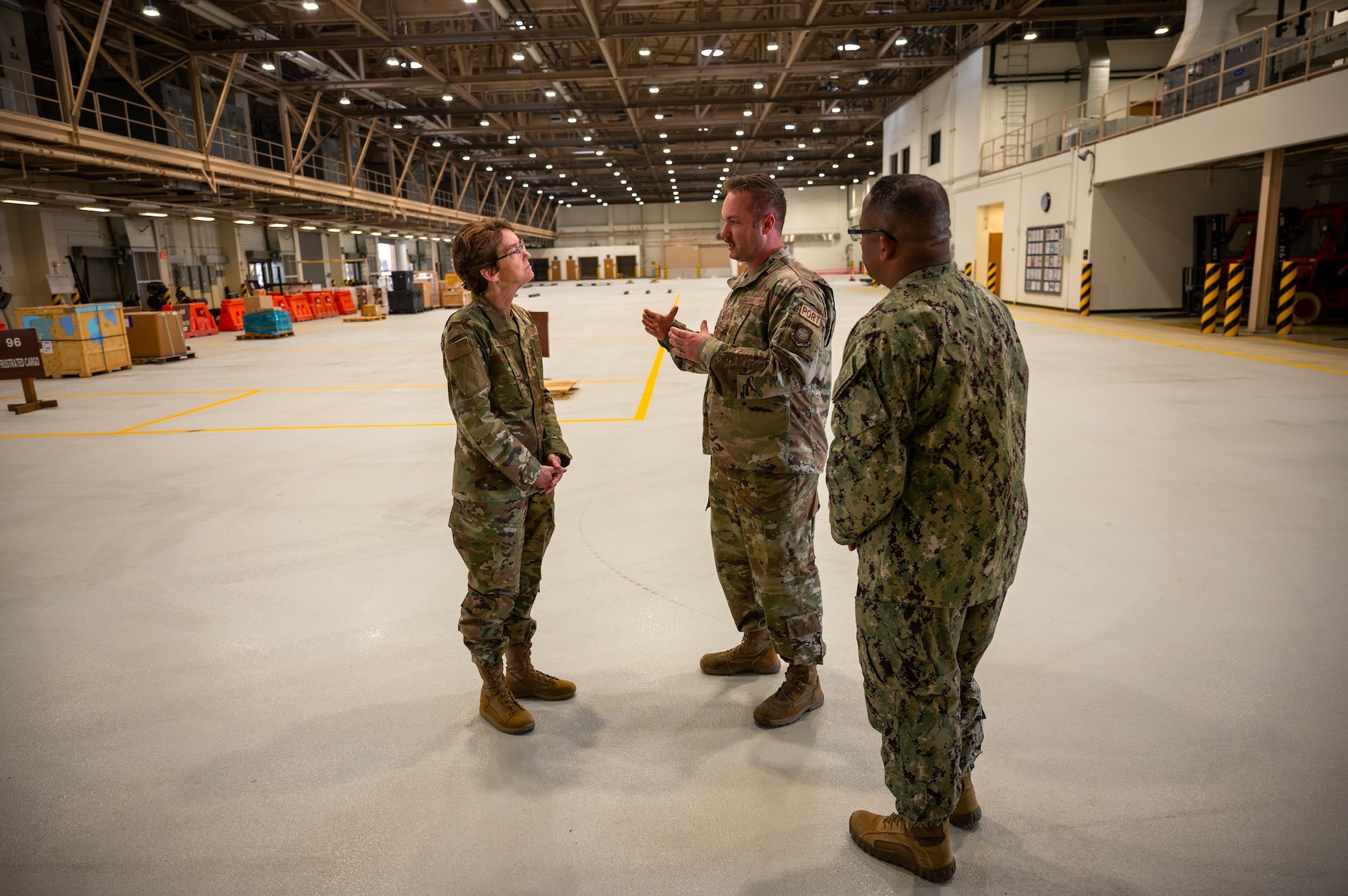 U.S. Air Force Master Sgt. Michael Perry, 731st Air Mobility Squadron, briefs U.S. Air Force Gen. Jacqueline D. Van Ovost, commander, U.S. Transportation Command (USTRANSCOM), and U.S. Navy Fleet Master Chief Donald Myrick, senior enlisted leader, USTRANSCOM, May 17, 2022, on Osan Air Base, Republic of Korea. The 731st AMS is responsible for ensuring the safety and fluid movement of all traveling personnel in and outbound via weekly rotators, tracking passenger manifests, handling baggage, and executing security checks and safety briefings for passengers. (U.S. Air Force photo by Tech. Sgt. Zachariah Lopez)