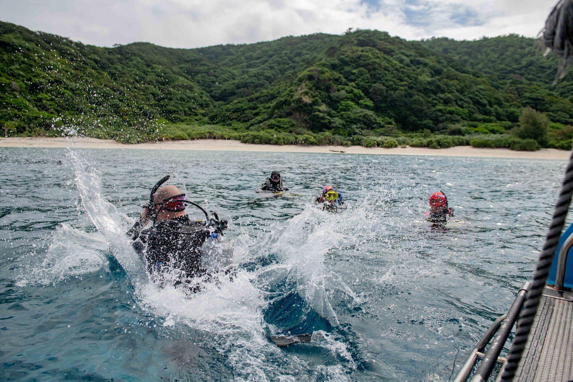 A diver makes a splash as he jumps into the ocean.