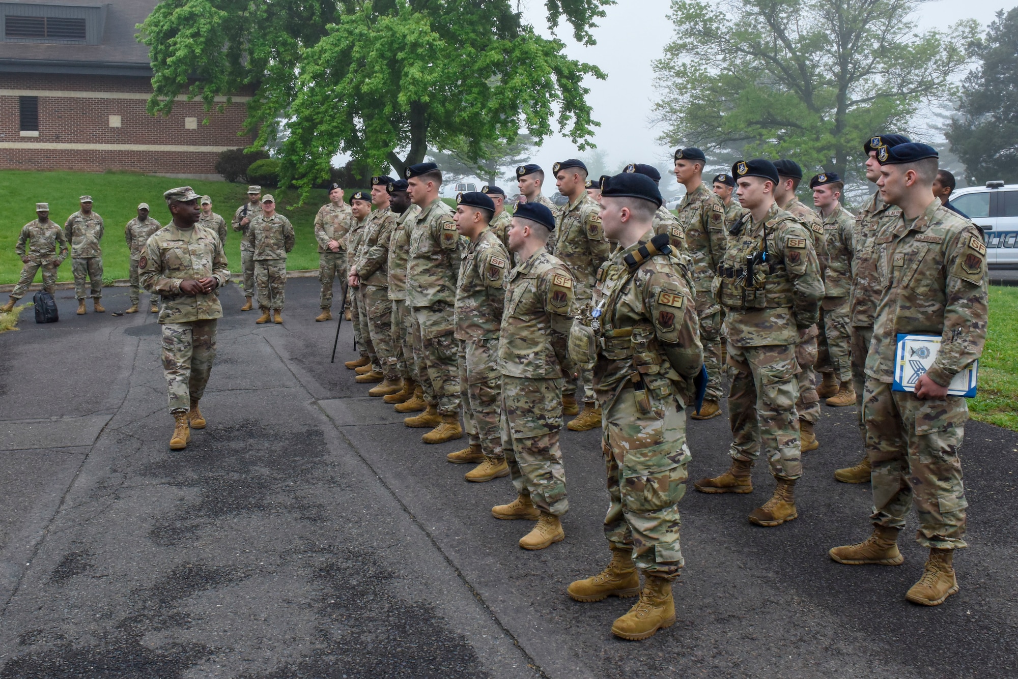 Man addressing men in military formation