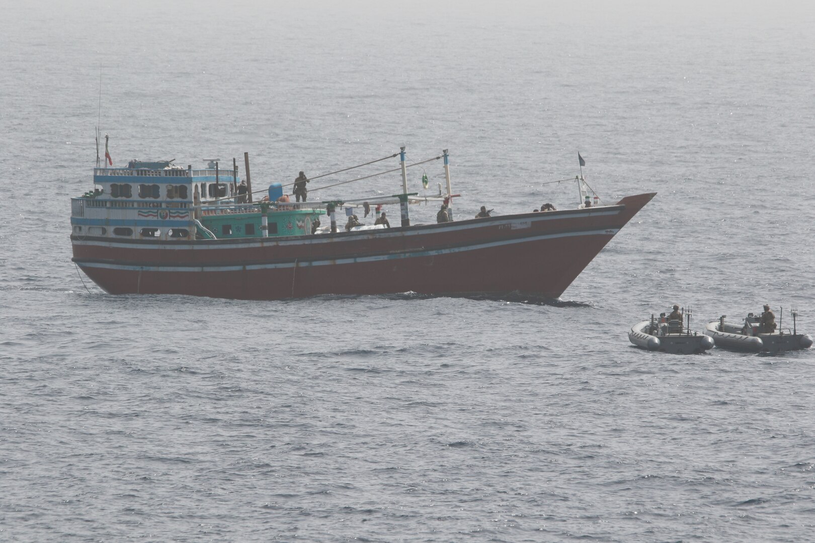 220516-N-TT059-1001 GULF OF OMAN (May 16, 2022) An interdiction team from guided-missile destroyer USS Momsen (DDG 92) approaches a fishing vessel May 16. The vessel was seized while transiting international waters in the Gulf of Oman.