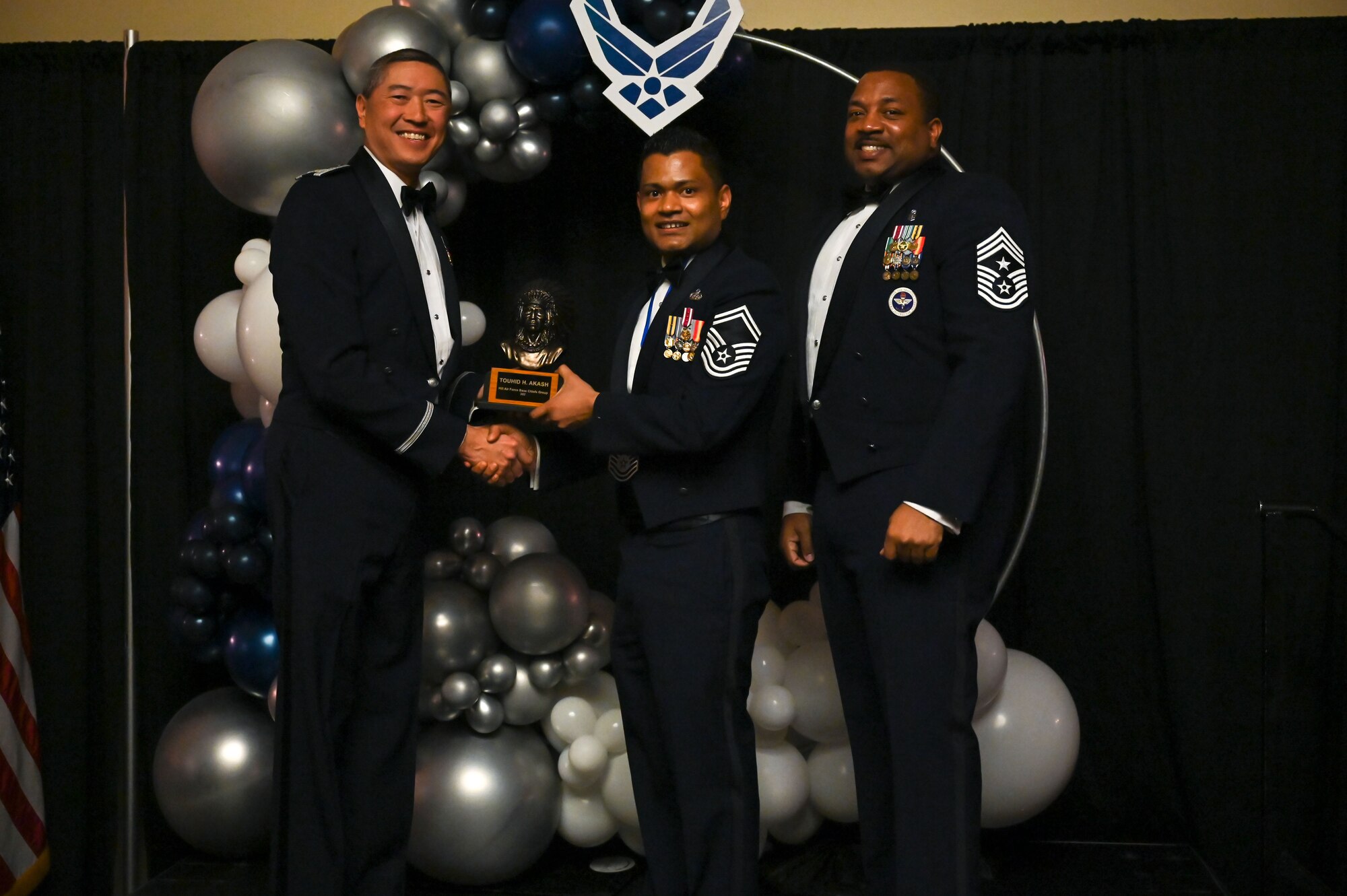 Chief Master Sgt. Touhid Akash (center), 75th Communications and Information Directorate, poses with Col. Peter Feng (left), 75th Air Base Wing vice commander, and Chief Master Sgt. Raymond Riley, 75th ABW command chief.