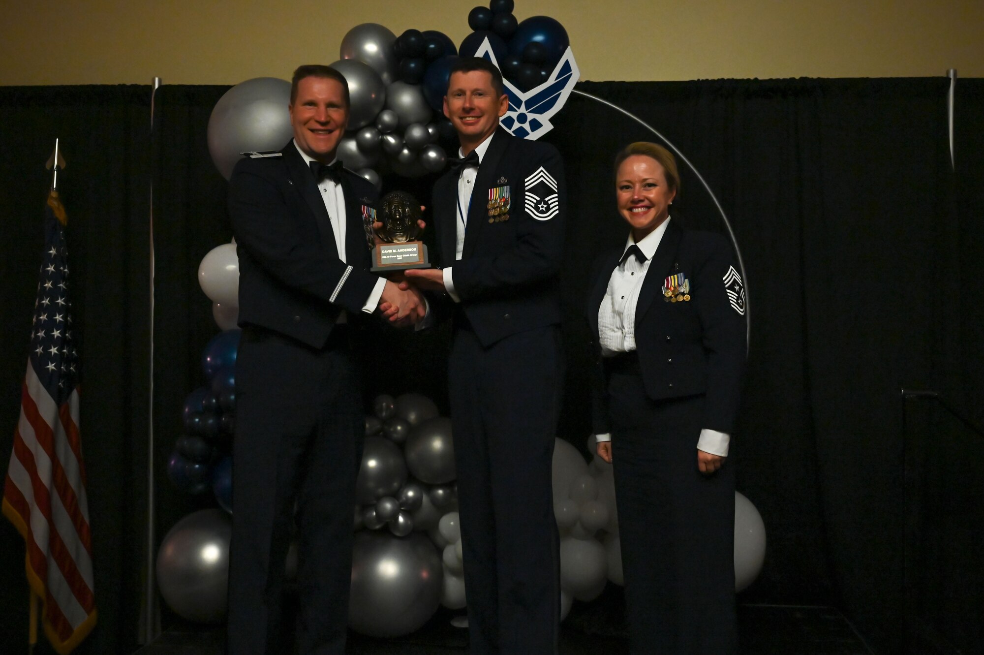 Chief Master Sgt. David Anderson (center), 419th Civil Engineer Squadron, poses with Col. Matthew Fritz (left), 419th Fighter Wing commander, and Chief Master Sgt. Heather Richins, 419th FW command chief