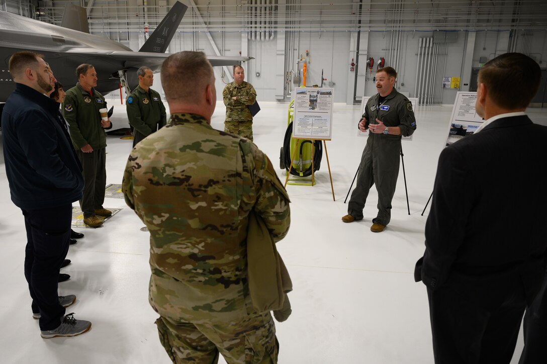 U.S. Air Force Lt. Col. Samuel Chipman, the 356th Fighter Squadron commander (right), briefs distinguished visitors May 13, 2022, on Eielson Air Force Base, Alaska.