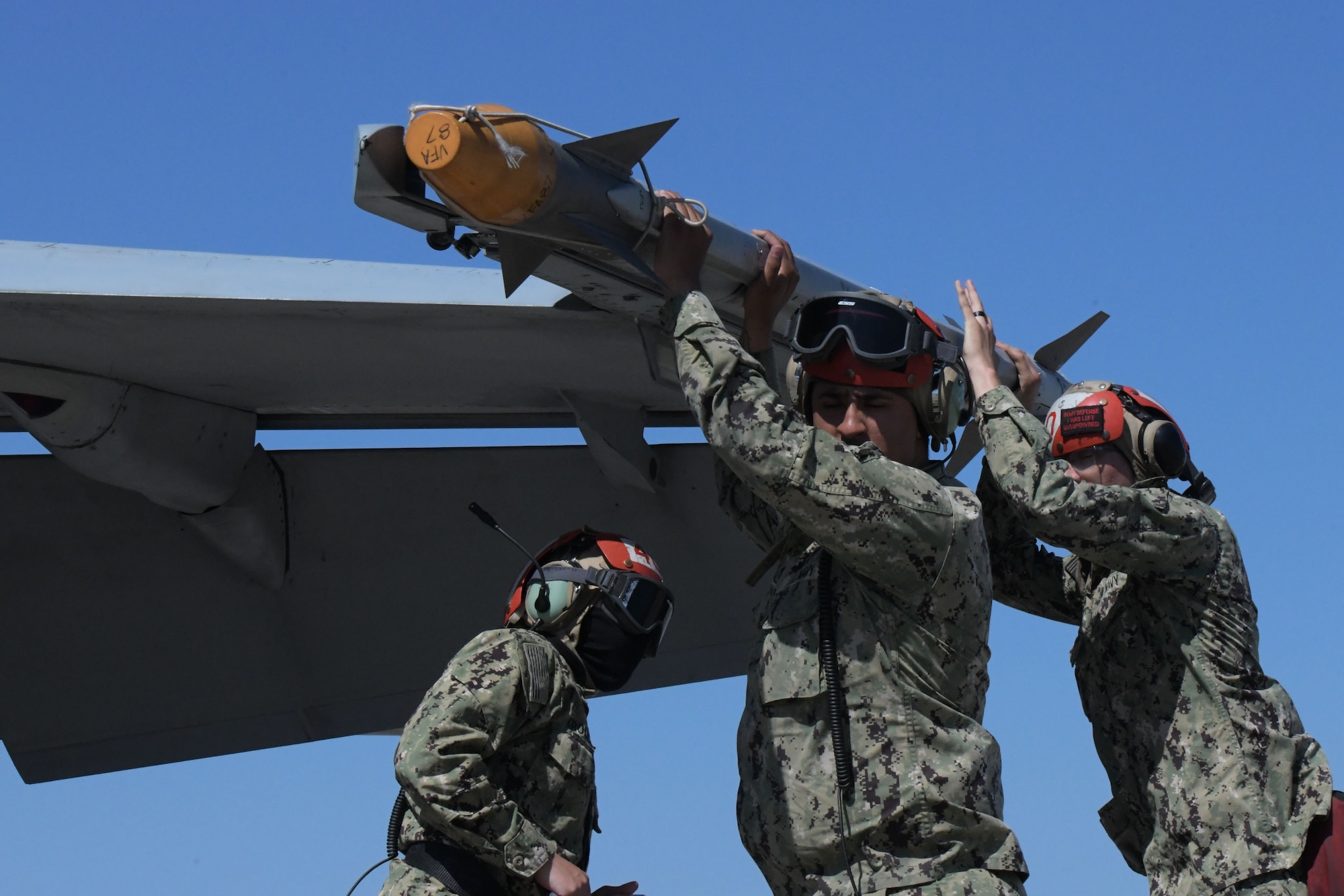 U.S. Sailors assigned to Strike Fighter Squadron (VFA) 83 remove an AIM-9X sidewinder missile from an F/A-18E Super Hornet at Tyndall Air Force Base, Florida, May 10, 2022.