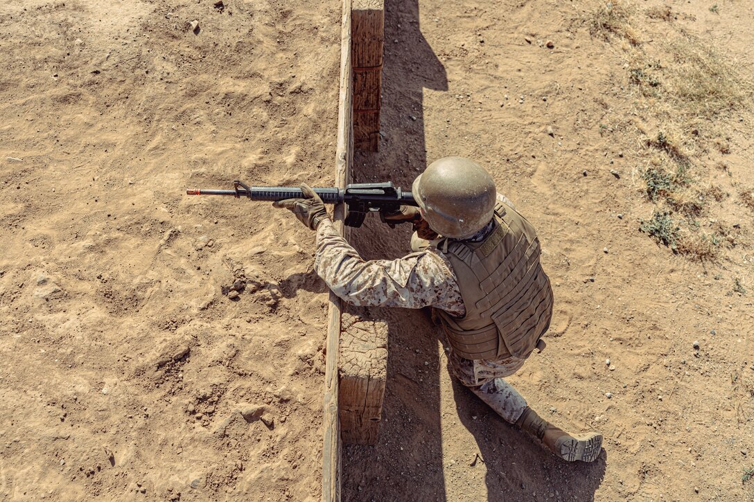 A U.S. Marine Corps officer candidate with Officer Selection Team San Diego, buddy rushes during an Officer Candidates School preparation weekend at Edson Range, Camp Pendleton, California on April 30, 2022. The OCS preparation weekend is designed to prepare aspiring Marine Corps officers mentally and physically for the rigors of OCS. (U.S. Marine Corps photo by Staff Sgt. Kelsey Dornfeld)