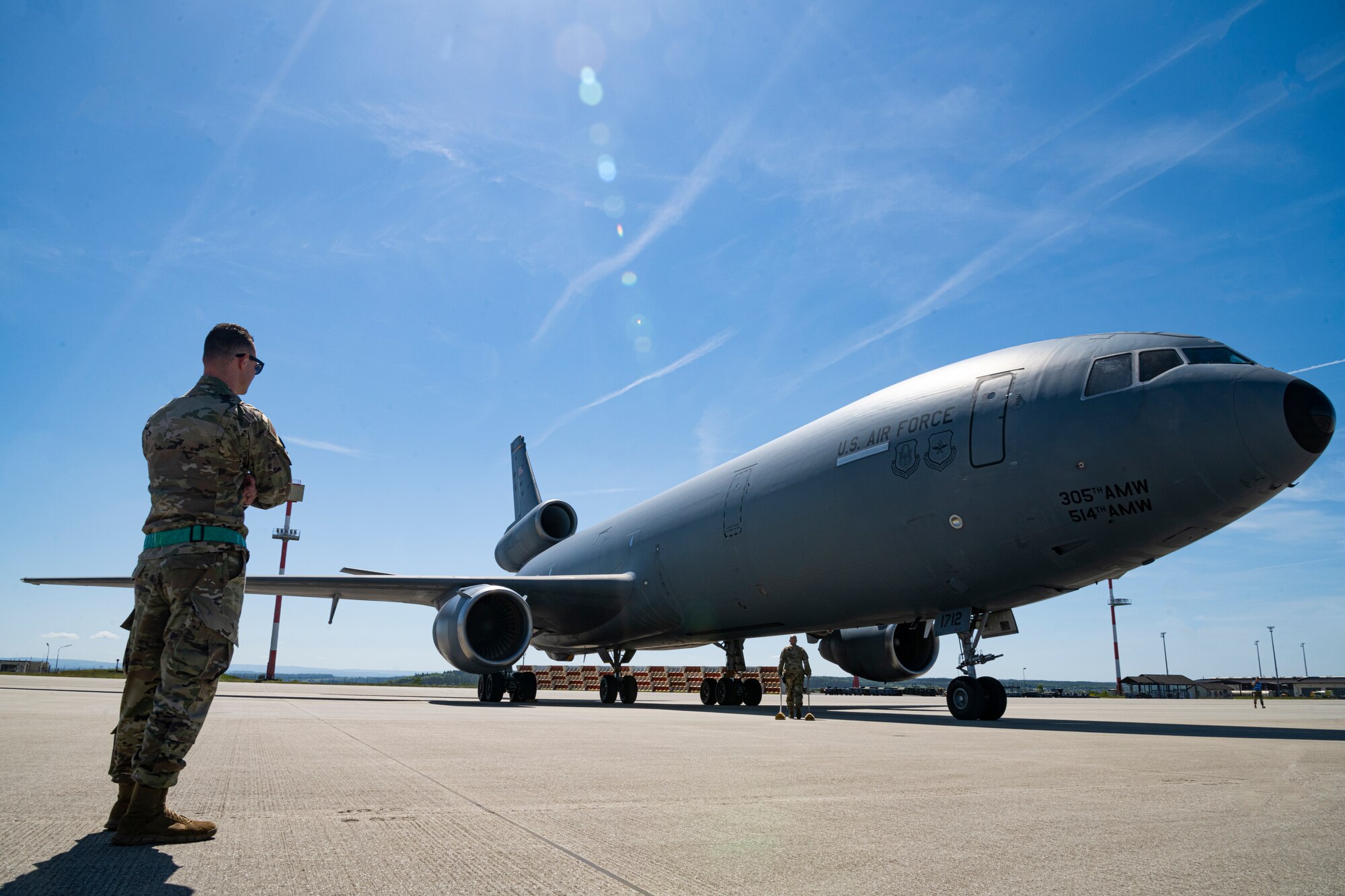 An Airman from the 726th Air Mobility Squadron at Spangdahlem Air Base, Germany, observes a KC-10 Extender aircraft assigned to the 305th Air Mobility Wing at Joint Base McGuire-Dix-Lakehurst, New Jersey, after it arrived at Spangdahlem AB, May 14, 2022. Movements such as these are designed to respond to the current security environment and reinforce the deterrent and defensive posture on NATO’s eastern flank. (U.S. Air Force photo by Senior Airman Ali Stewart)