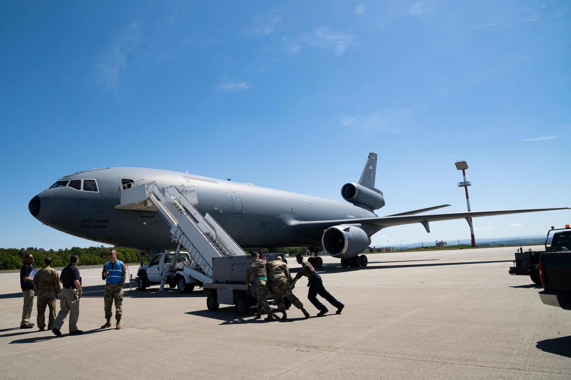 Airmen from the 726th Air Mobility Squadron at Spangdahlem Air Base, Germany, prepare to offload passengers from A KC-10 Extender aircraft that arrived from the 305th Air Mobility Wing at Joint Base McGuire-Dix-Lakehurst, New Jersey, May 14, 2022. The 305th AMW generates, mobilizes and deploys C-17 Globemaster III and KC-10 Extender aircraft and are currently supporting operations within the European theater. (U.S. Air Force photo by Senior Airman Ali Stewart)