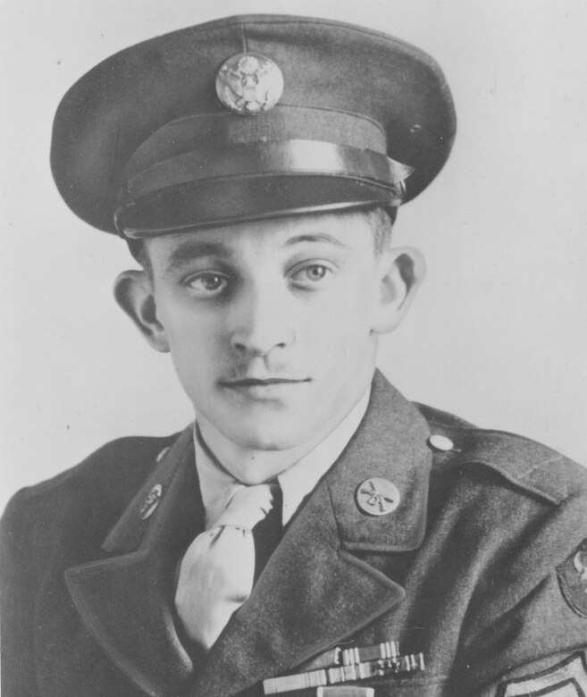 A man in service uniform and cap poses for a photo.