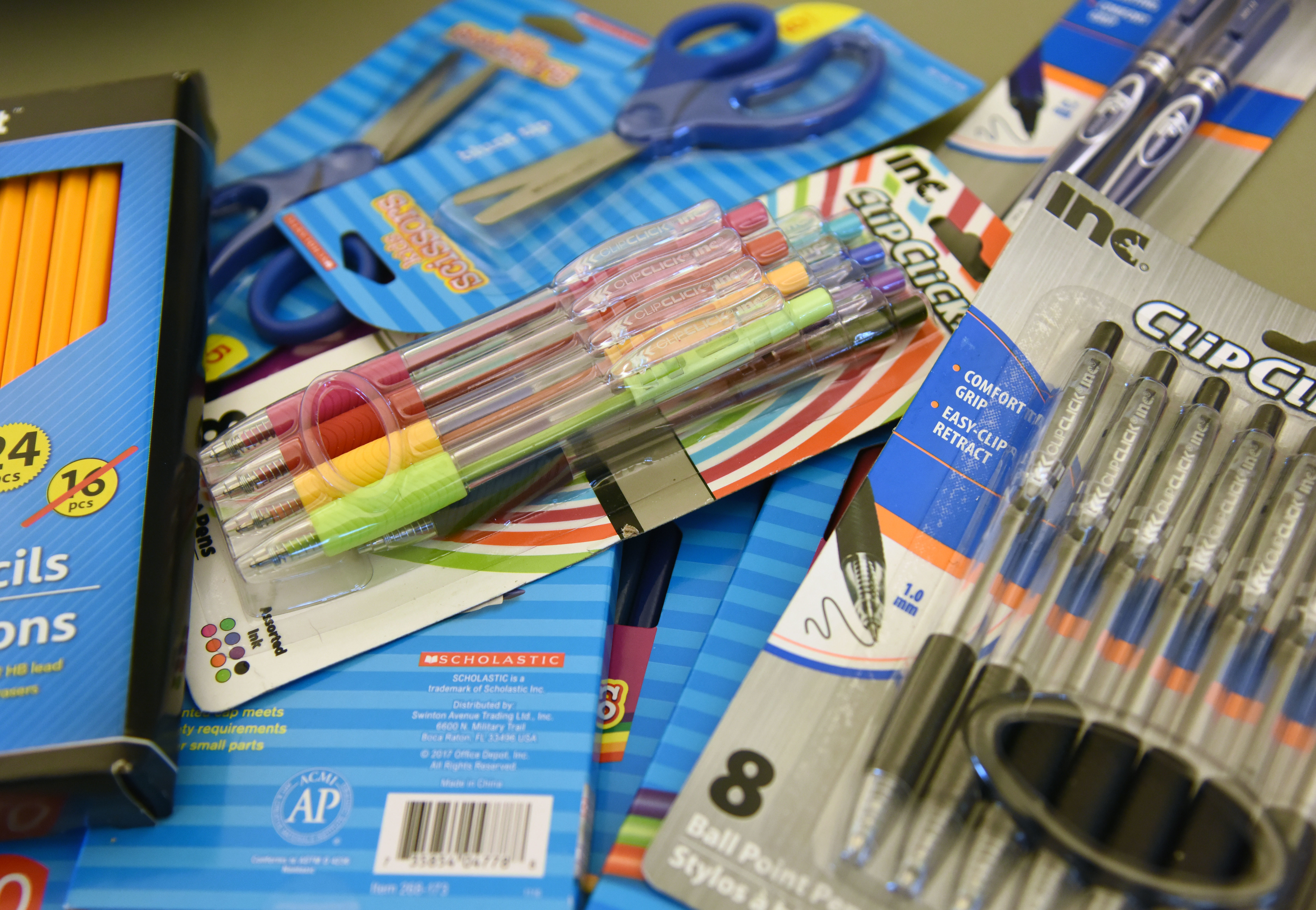 Assorted school supplies are displayed on a table